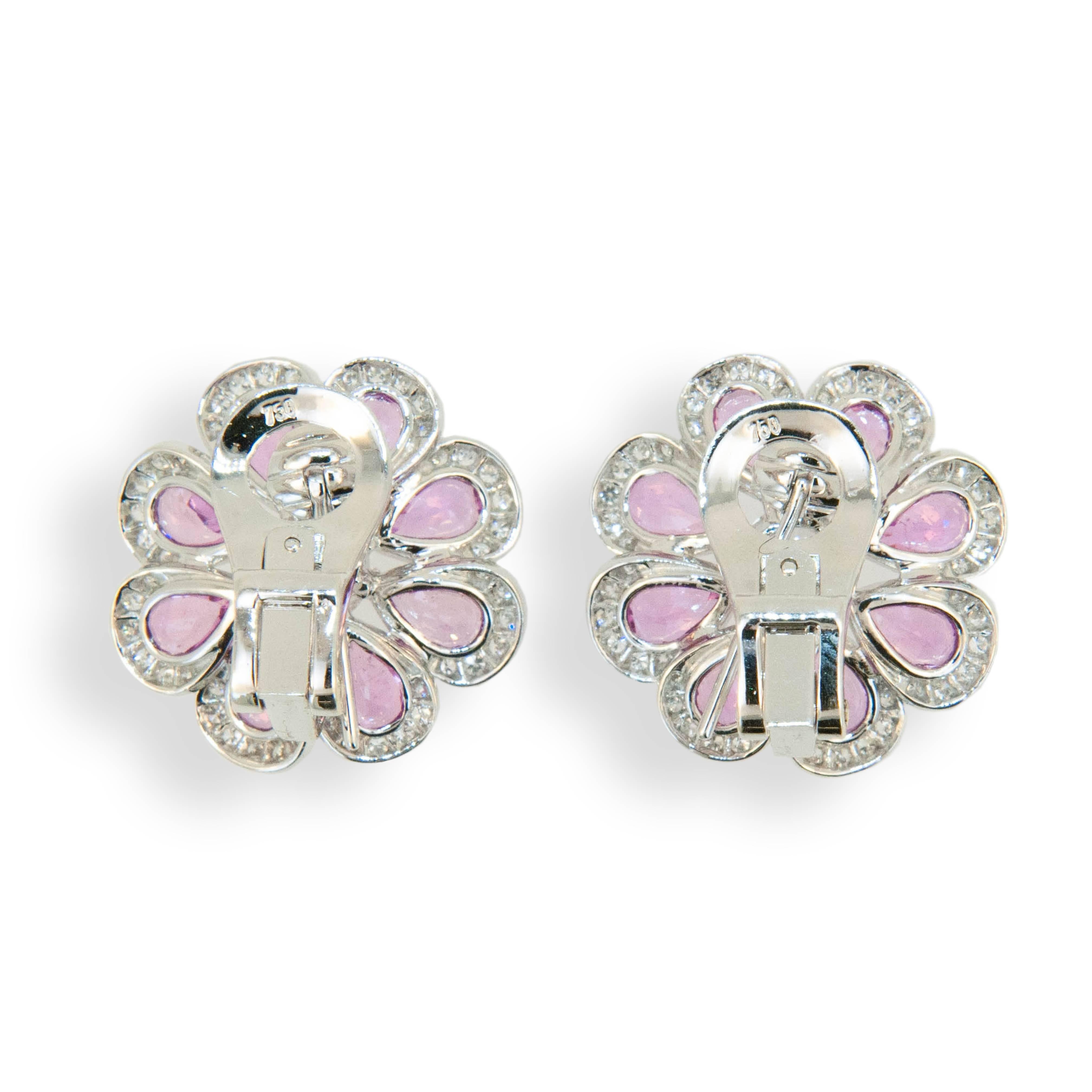 18 karat white gold earrings flower shape set with (16) pear shaped Pink Sapphires 7.73 carats total weight. Center is set with one rose cut diamond (2) .74 carat total weight. Edges of petals are set with (96) Diamonds .69 carat total weight.