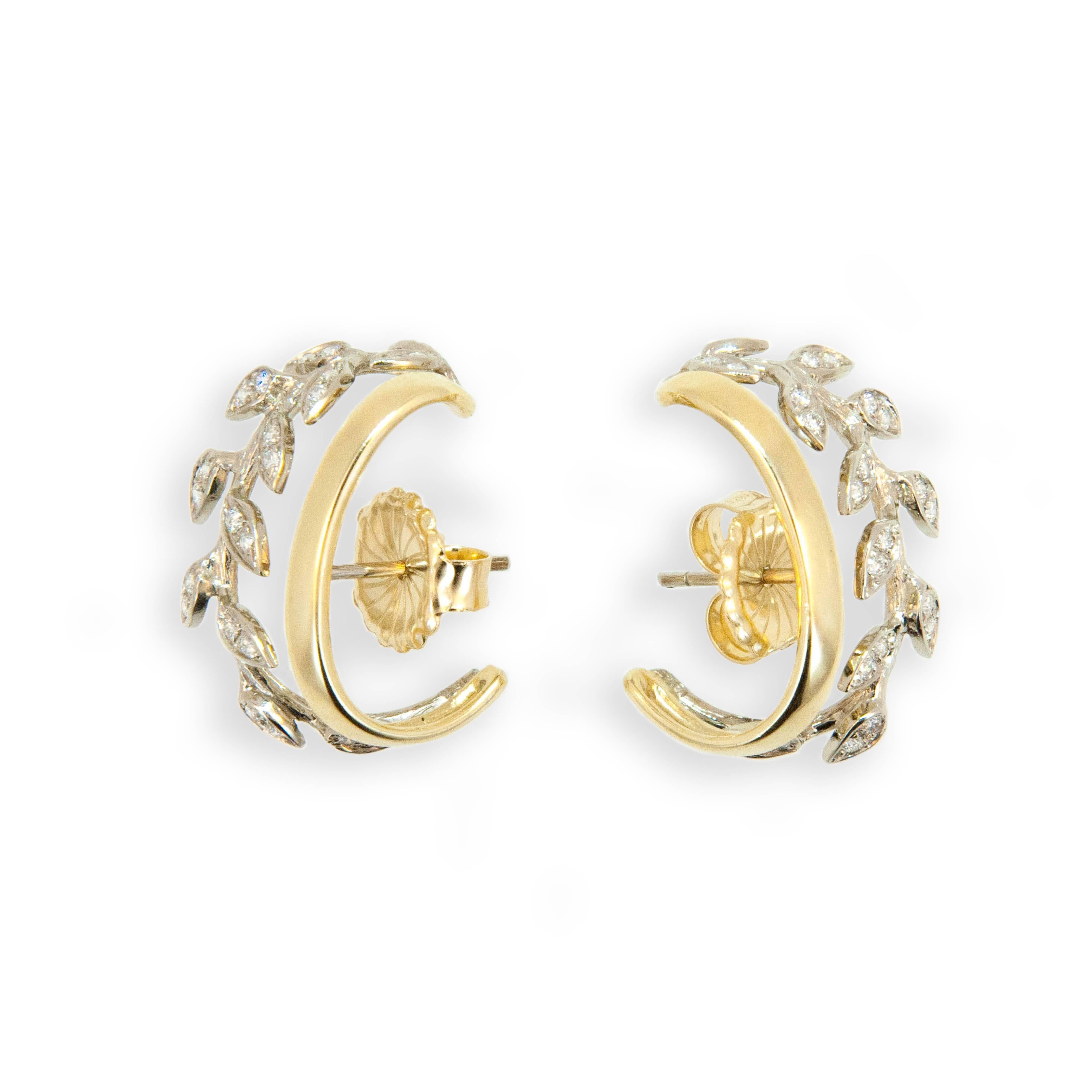 New to the Laura Munder Collection! 18 karat yellow and white gold leaf hoop earrings each set with 23 round 1.2 - 1.3 mm full cut diamonds H/SI-1 approximately .45 carat total weight. 