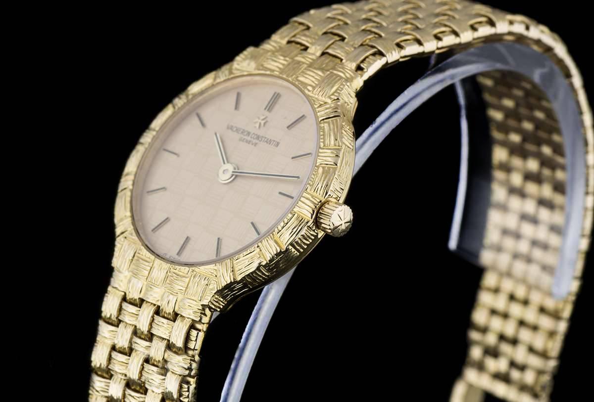 An 18k Yellow Gold Ladies Wristwatch 27046, champagne dial with applied index batons, a fixed polished patterned 18k yellow gold bezel, a polished woven 18k yellow gold bracelet with an 18k yellow gold jewellery style clasp, mineral glass, quartz