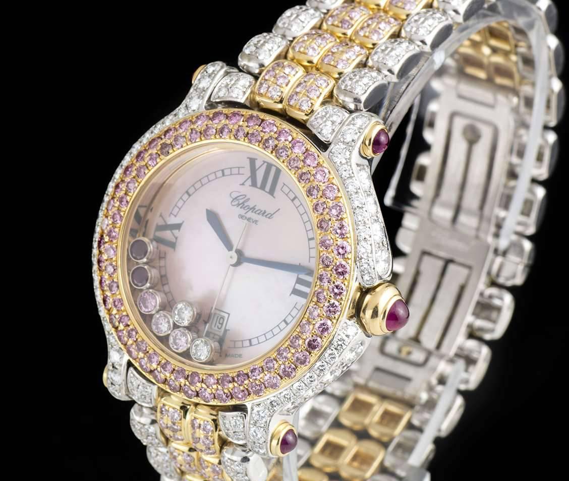 A Yellow Gold & White Gold Fully Loaded Happy Sport Ladies Wristwatch, pink mother of pearl dial with roman numerals III, VI, IX & XII, date at 6 0'clock, 2 floating round cut rubies, 3 floating round brilliant cut pink diamonds & 2