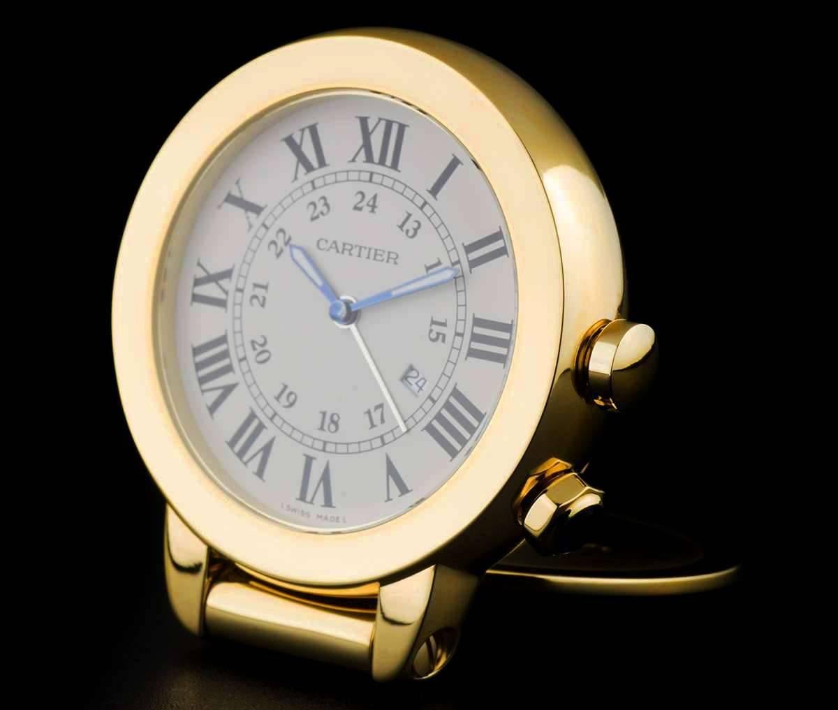 A Gold Plated Ronde Solo Travel Alarm Clock, white dial with roman numerals and a secret signature at "X", date aperture at 4 0'clock, a fixed gold plated bezel, crown to set the alarm at 3 0'clock, mineral glass, quartz movement, in