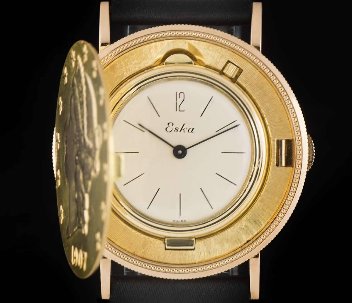 A Gold 20 Dollar Coin Gents Wristwatch, the gold 20 dollar outer case - the front of the coin is engraved with the Liberty Head and the date "1907", silver dial with hour markers, a fixed gold bezel, plastic glass, the caseback is the