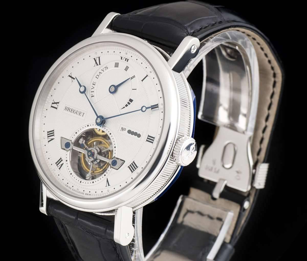 A Platinum Tourbillon Power Reserve Gents Wristwatch, silvered gold dial hand engraved on a rose engine, silver outer chapter ring with roman numerals, small seconds on tourbillon display at 6 0'clock, power reserve display at 12 0'clock, a fixed