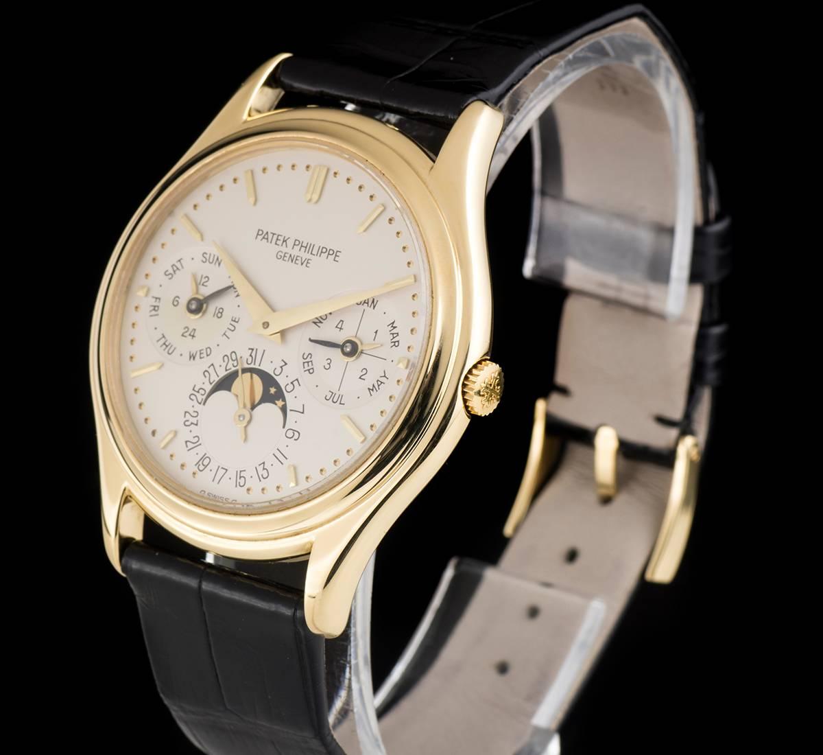 An 18k Yellow Gold Perpetual Calendar Gents Wristwatch, silver dial with applied hour markers, month and leap year indicator at 3 0'clock, date and moonphase aperture at 6 0'clock, weekday and am/pm indicator at 9 0'clock, a fixed 18k yellow gold