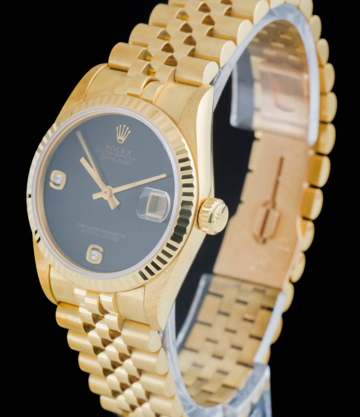 An Unworn 18k Yellow Gold Oyster Perpetual Datejust NOS Mid-Size Wristwatch, rare onyx dial with applied arabic numbers 6 and 9 each set with a round brilliant cut diamond, date at 3 0'clock, a fixed 18k yellow gold fluted bezel, an 18k yellow gold