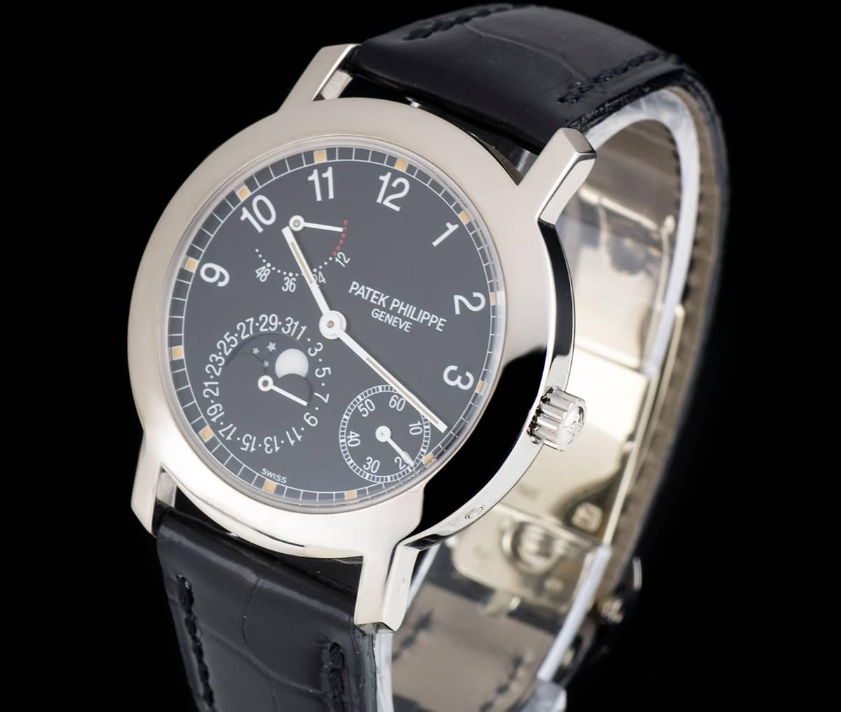 An 18k White Gold Moonphase Power Reserve Gents Wristwatch, black dial with arabic numbers, small seconds between 4 and 5 0'clock, date sub-dial with moonphase aperture at 7 0'clock, power reserve indicator between 10 and 11 0'clock, a fixed 18k