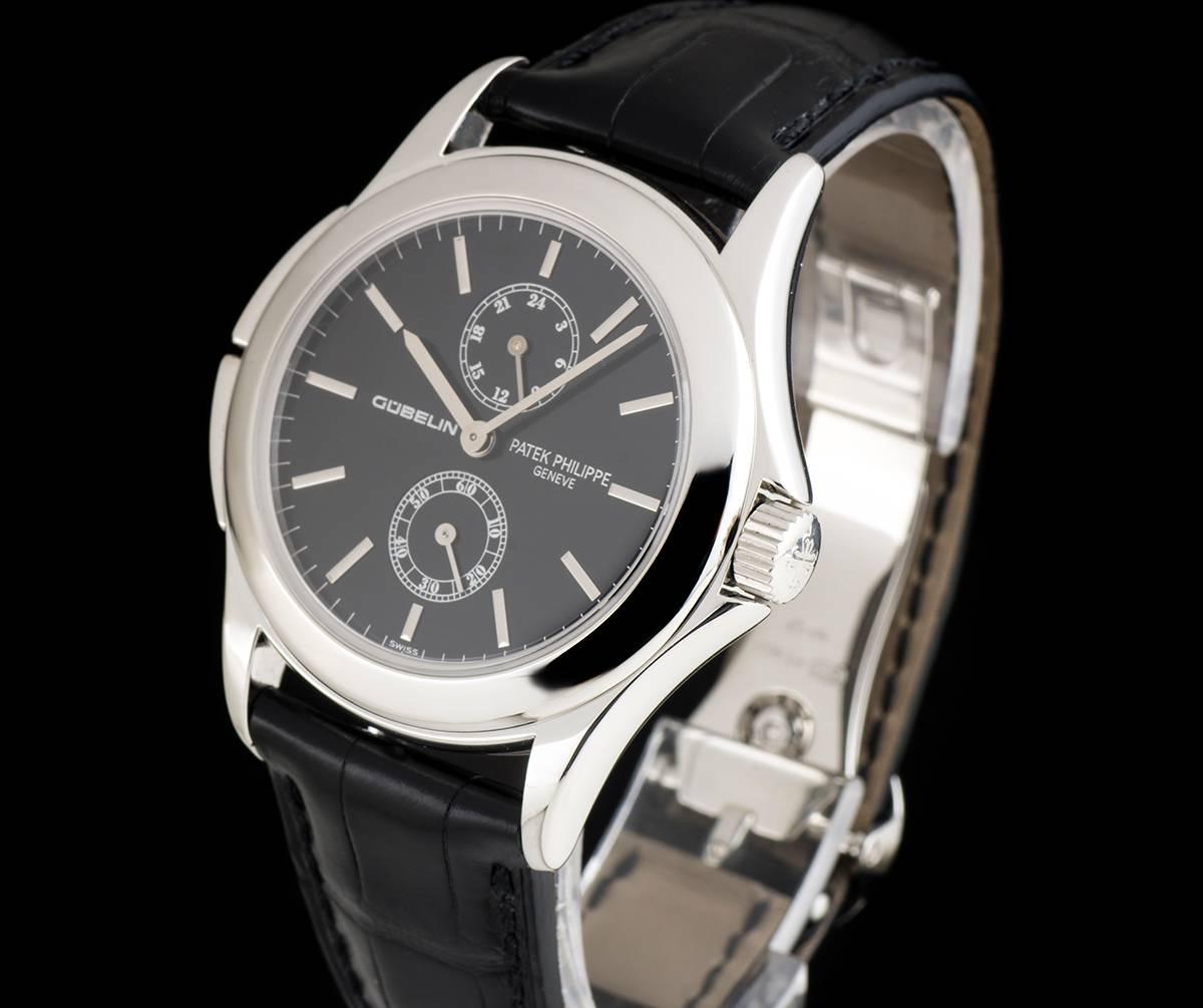 A Platinum "Double Name" Calatrava Travel Time Gents Wristwatch, black dial (retailed by Gübelin) with applied hour markers, small seconds at 6 0'clock, 24-hour display at 12 0'clock, a fixed platinum bezel, a brand new original black