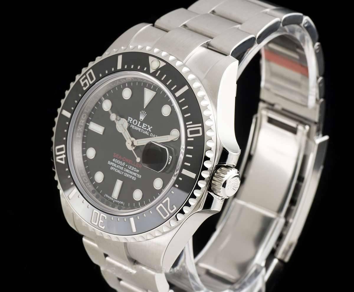 An Unworn Stainless Steel Oyster Perpetual Red Writing Sea-Dweller Gents Wristwatch, black dial with applied hour markers, date at 3 0'clock, a stainless steel uni-directional rotating bezel with a black ceramic insert, a stainless steel oyster
