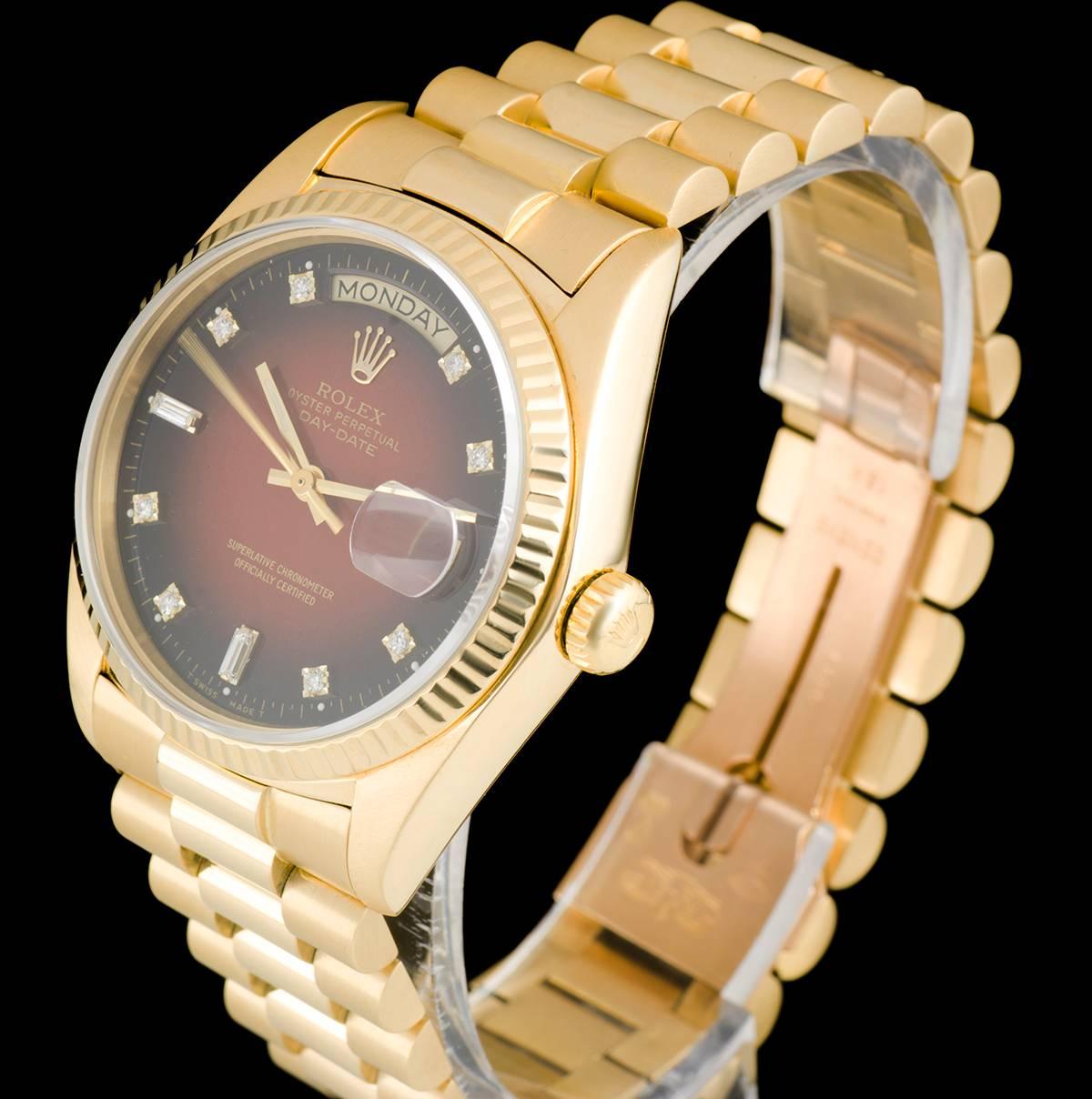 An 18k Yellow Gold Oyster Perpetual Day-Date Gents Wristwatch, maroon vignette dial with 8 applied round brilliant cut diamond hour markers and 2 baguette cut diamond hour markers, day aperture at 12 0'clock, date at 3 0'clock, a fixed 18k yellow