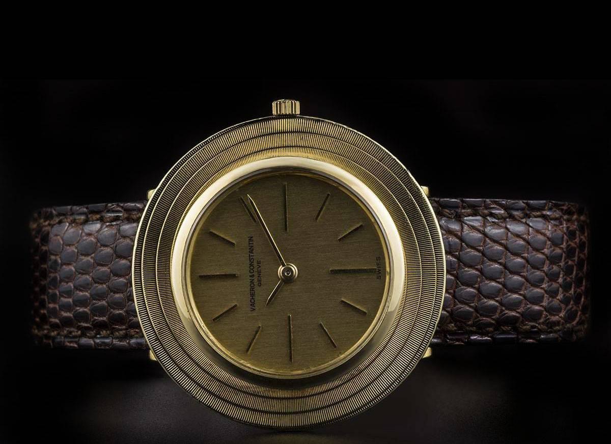 A 18k Yellow Gold Ultra Slim Vintage Gents Wristwatch, champagne dial with index batons, an 18k yellow gold unusual circular bezel, a brown leather strap (not by Vacheron Constantin) with an 18k yellow gold pin buckle (not by Vacheron Constanting),