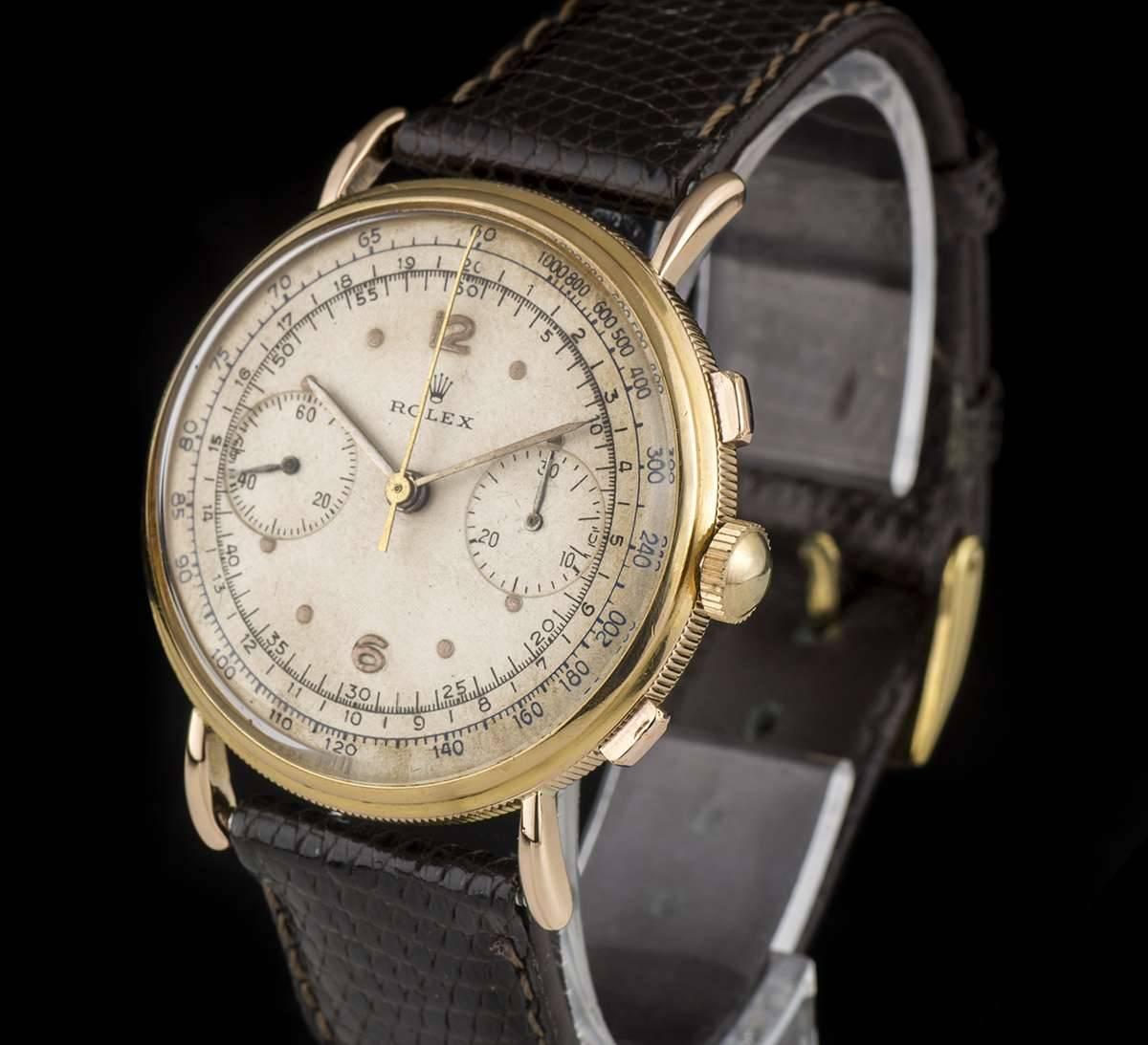 An 18k Yellow Gold Vintage Chronograph Gents Wristwatch, silver dial with applied roman numerals and applied arabic numbers at 6 and 12 0'clock, a fixed 18k yellow gold bezel, an 18k yellow gold "coin edge" case, a brand new brown leather
