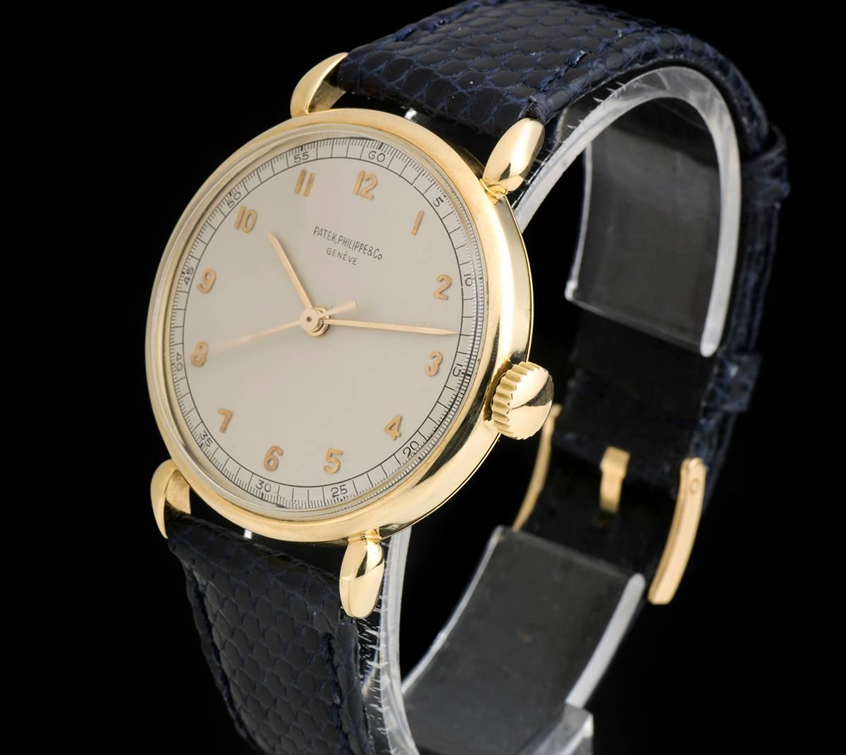 An 18k Yellow Gold Calatrava Indirect Centre Seconds Vintage Gents Wristwatch, silvered dial with applied arabic numbers, a fixed 18k yellow gold bezel, 18k yellow gold tear drop lugs, a blue leather strap (not by Patek Philippe) with an original