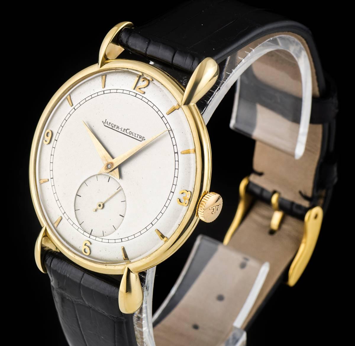 An 18k Yellow Gold Vintage Gents Dress Wristwatch, silver dial with applied hour markers and applied arabic numbers 3, 6, 9 and 12, small seconds at 6 0'clock, a fixed 18k yellow gold bezel, 18k yellow gold fancy lugs, a brand new black leather