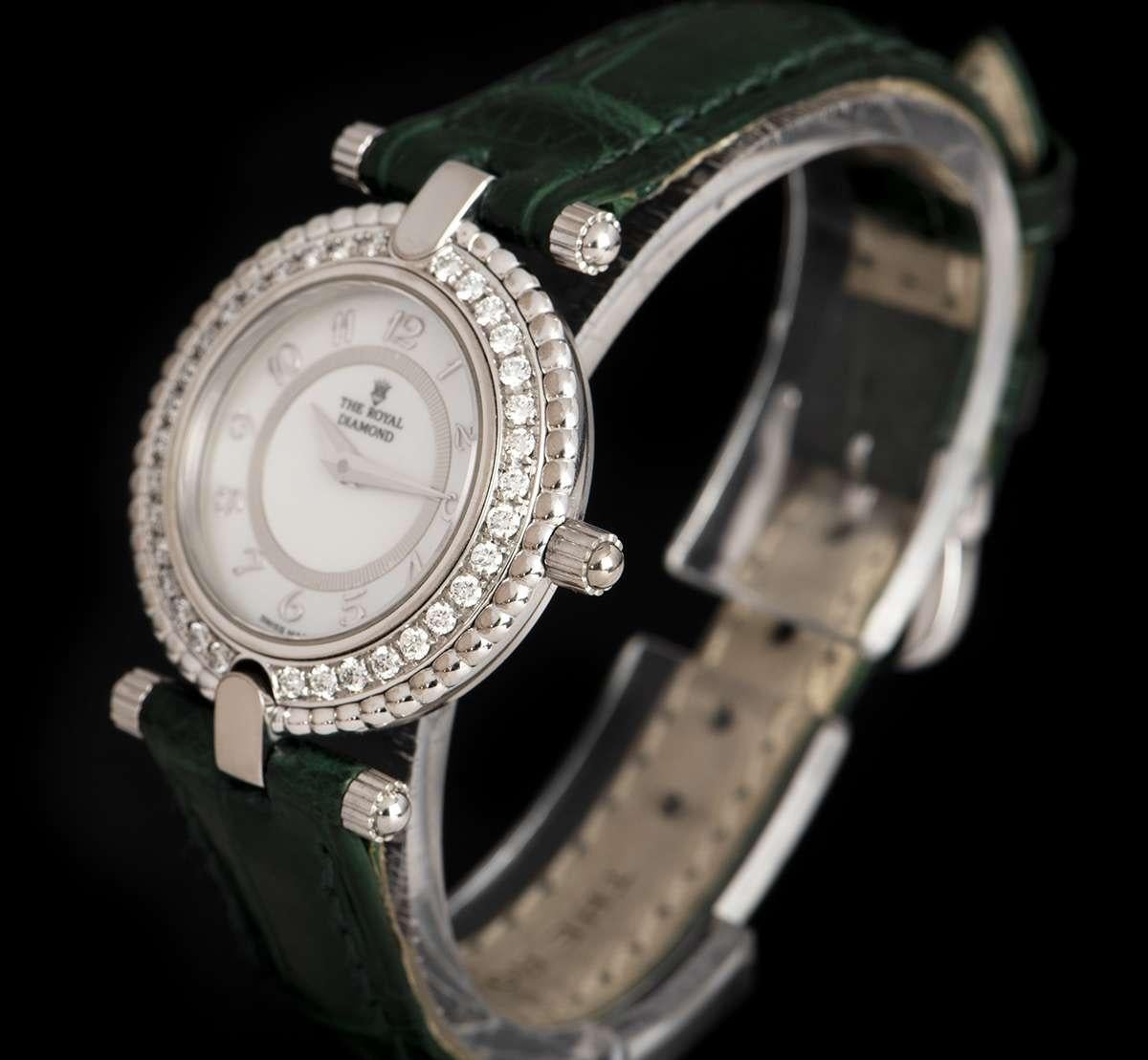 An 18k White Gold Ladies Dress Wristwatch, white mother of pearl dial with applied arabic numbers, a fixed 18k white gold bezel set with approximately 34 round brilliant cut diamonds (~0.49ct), an original green leather strap with a stainless steel