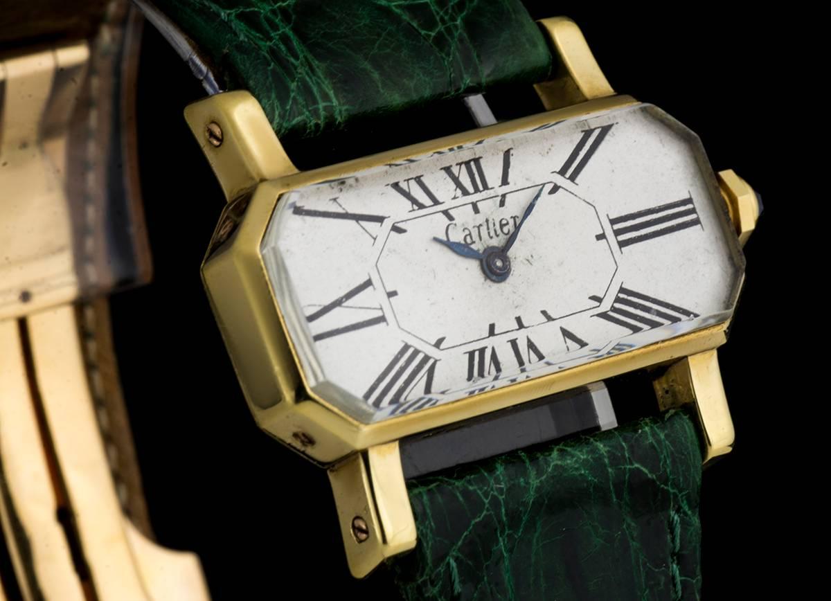 An 18k Yellow Gold Ladies Vintage Divan Wristwatch 32207, original white dial with roman numerals, winding crown set with a faceted blue sapphire, green leather strap with an original 18k yellow gold deployant clasp, plastic glass, manual wind