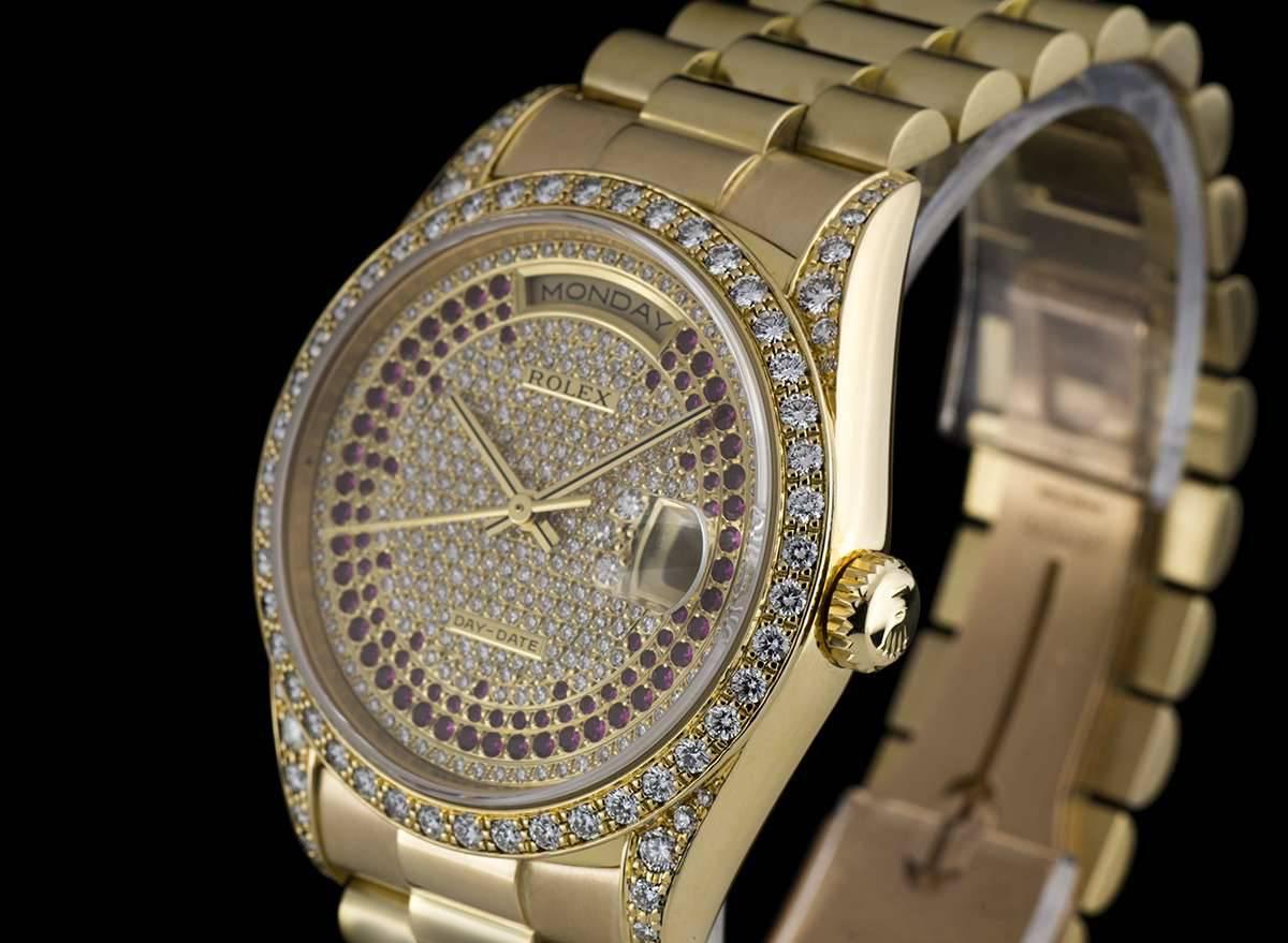 An 18k Yellow Gold Day-Date Wristwatch 18388, rare pavé set diamond and ruby dial, day at 12 0'clock, date at 3 0'clock, a fixed 18k yellow gold bezel set with approximately 44 round brilliant diamonds, 18k yellow gold lugs each set with
