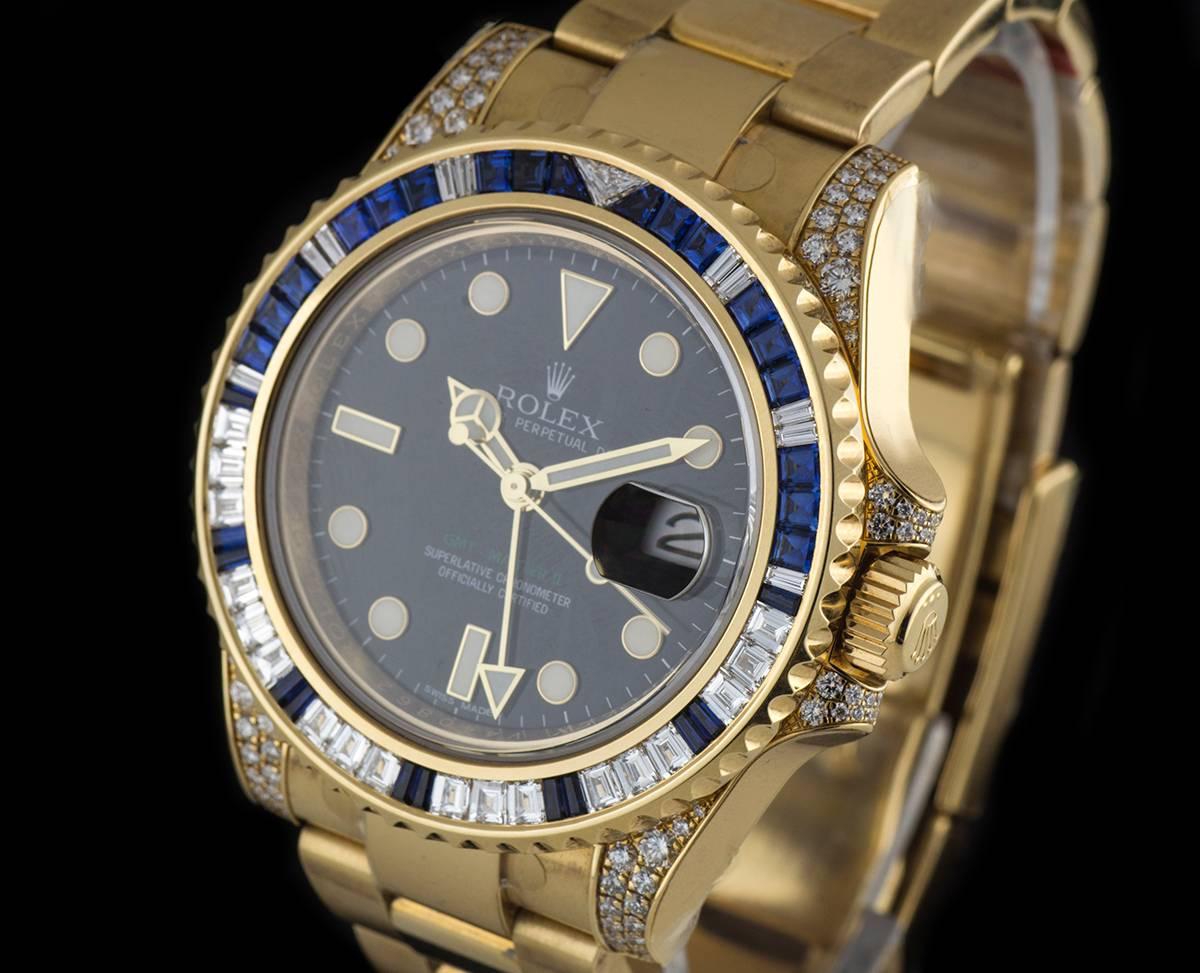 A Yellow Gold Oyster Perpetual GMT-Master II Gents Wristwatch, black dial with applied hour markers, date at 3 0'clock, a yellow gold bi-directional rotating bezel set with 30 baguette cut sapphires ~ 1.95ct and 29 baguette cut diamonds ~ 1.55ct,