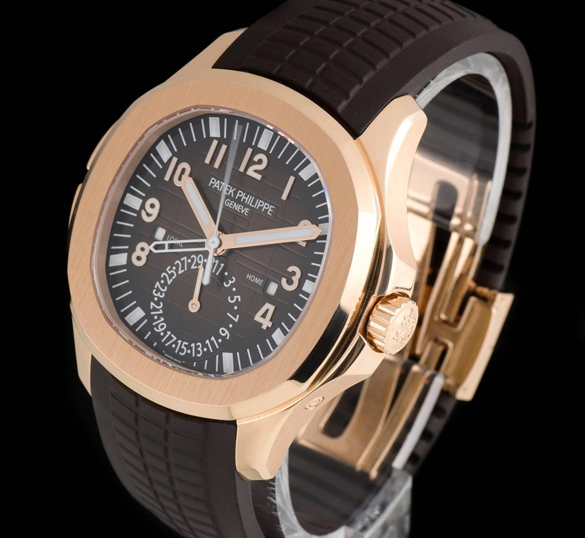 An 18k Rose Gold Aquanaut Travel Time Gents Wristwatch, brown embossed dial with applied arabic numbers, date at 6 0'clock, dual time zone function, AM/PM indicator, a fixed 18k rose gold bezel, an original brown "Tropical" composite