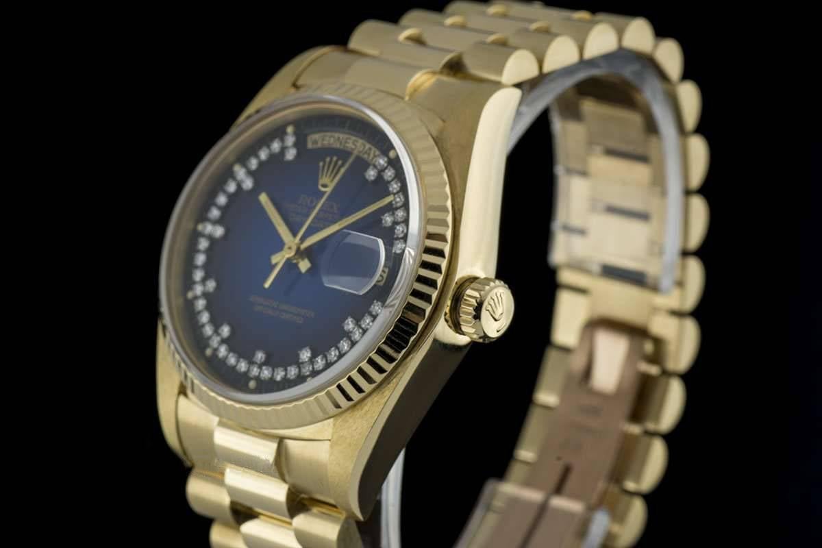 An 18k Yellow Gold Oyster Perpetual Day-Date Gents Wristwatch, blue vignette string diamond dial set with approximately 48 applied round brilliant cut diamonds, day aperture at 12 0'clock, date aperture at 3 0'clock, an 18k yellow gold fixed fluted