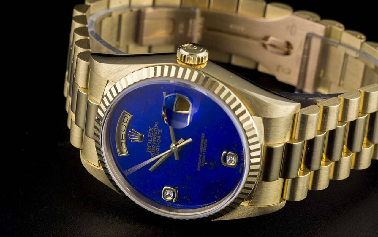 An 18k Yellow Gold Oyster Perpetual Day-Date Gents Wristwatch, rare lapis lazuli dial with applied arabic numbers 6 and 9 each set with a round brilliant cut diamond, a fixed 18k yellow gold fluted bezel, an 18k yellow gold brushed and polished