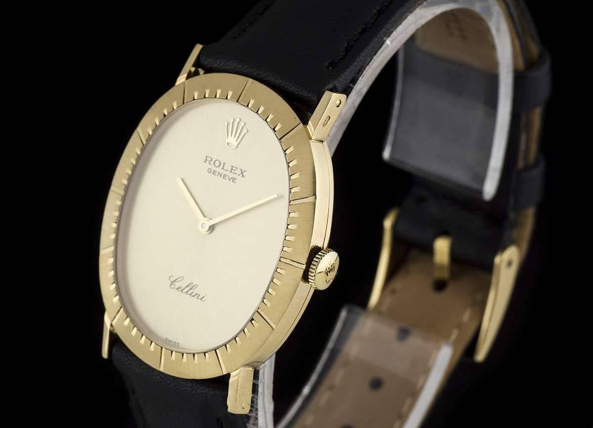 An 18k Yellow Gold Oval Cellini Gents Wristwatch, champagne dial, a fixed 18k yellow gold brushed bezel with engraved hour markers, a black leather strap (not by Rolex) with an original 18k yellow gold pin buckle, mineral glass, manual wind