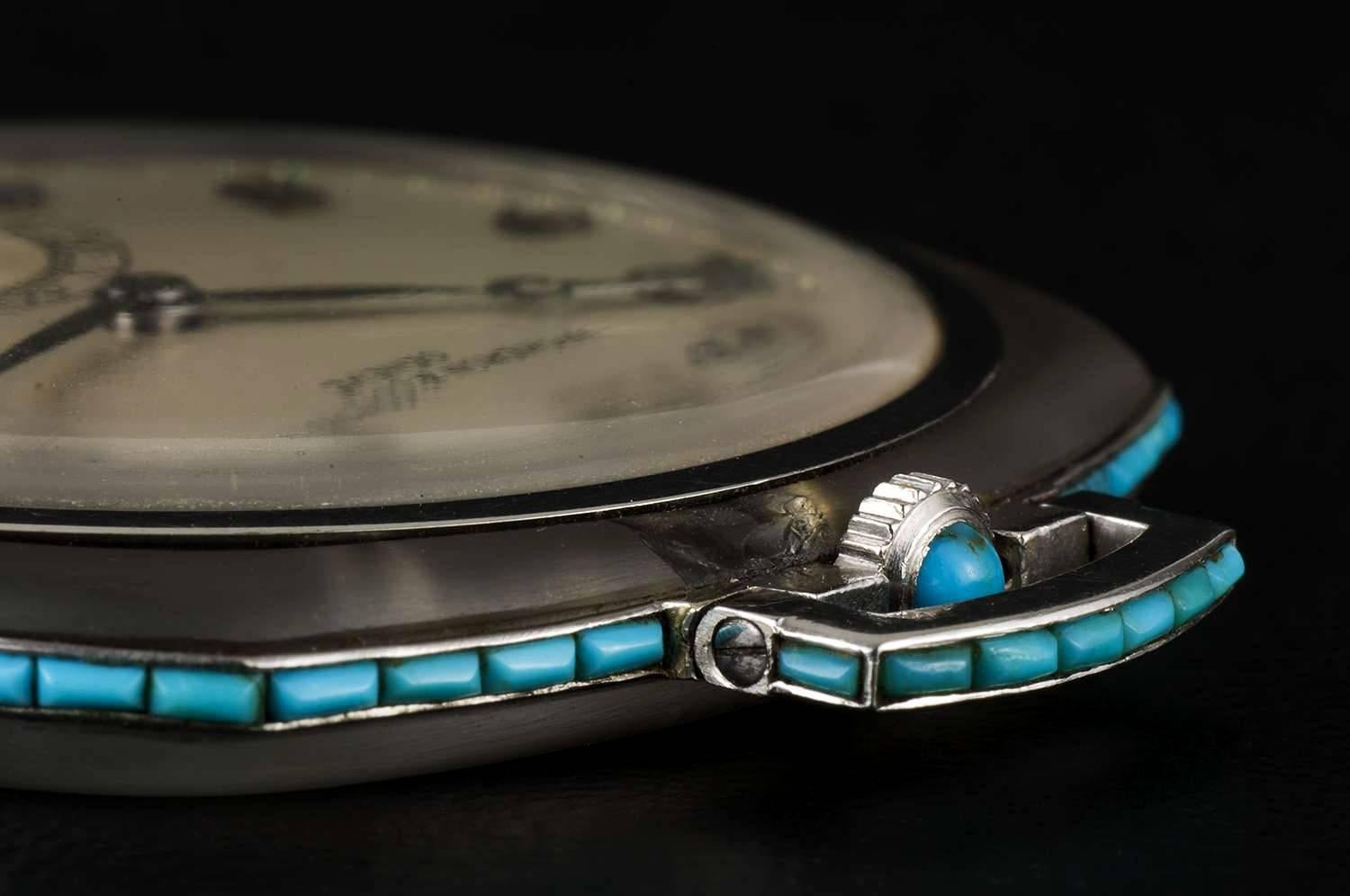 This is a fine rare square shape pocket watch made of Gold, Rock Crystal, and with a turquoise surround, silver dial with arabic numbers, small seconds at 6 0'clock and breguet style moon hands, the winding crown is set with a cabochon turquoise,