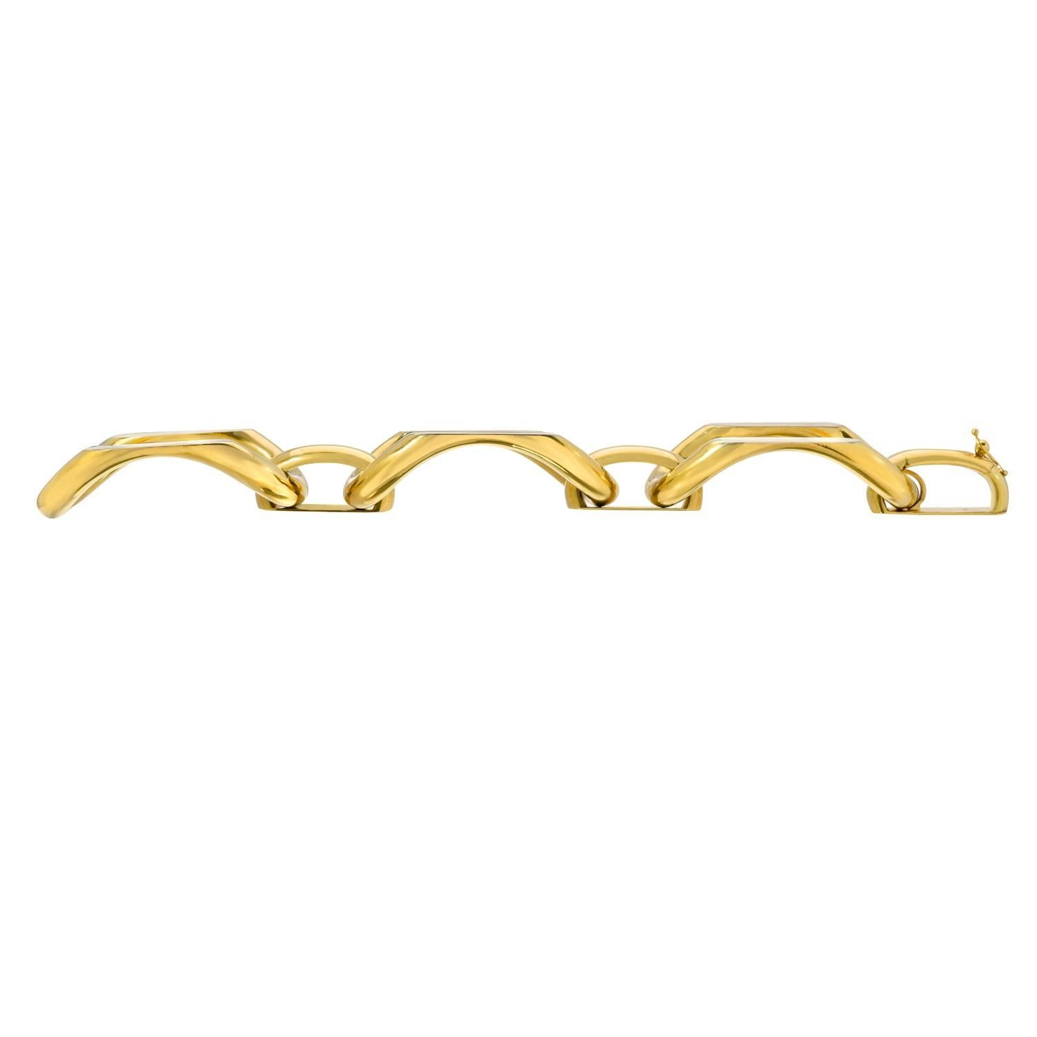 Designed as a series of geometric arched gold links, the top of each with white gold detail, the smaller arched gold spacers  

