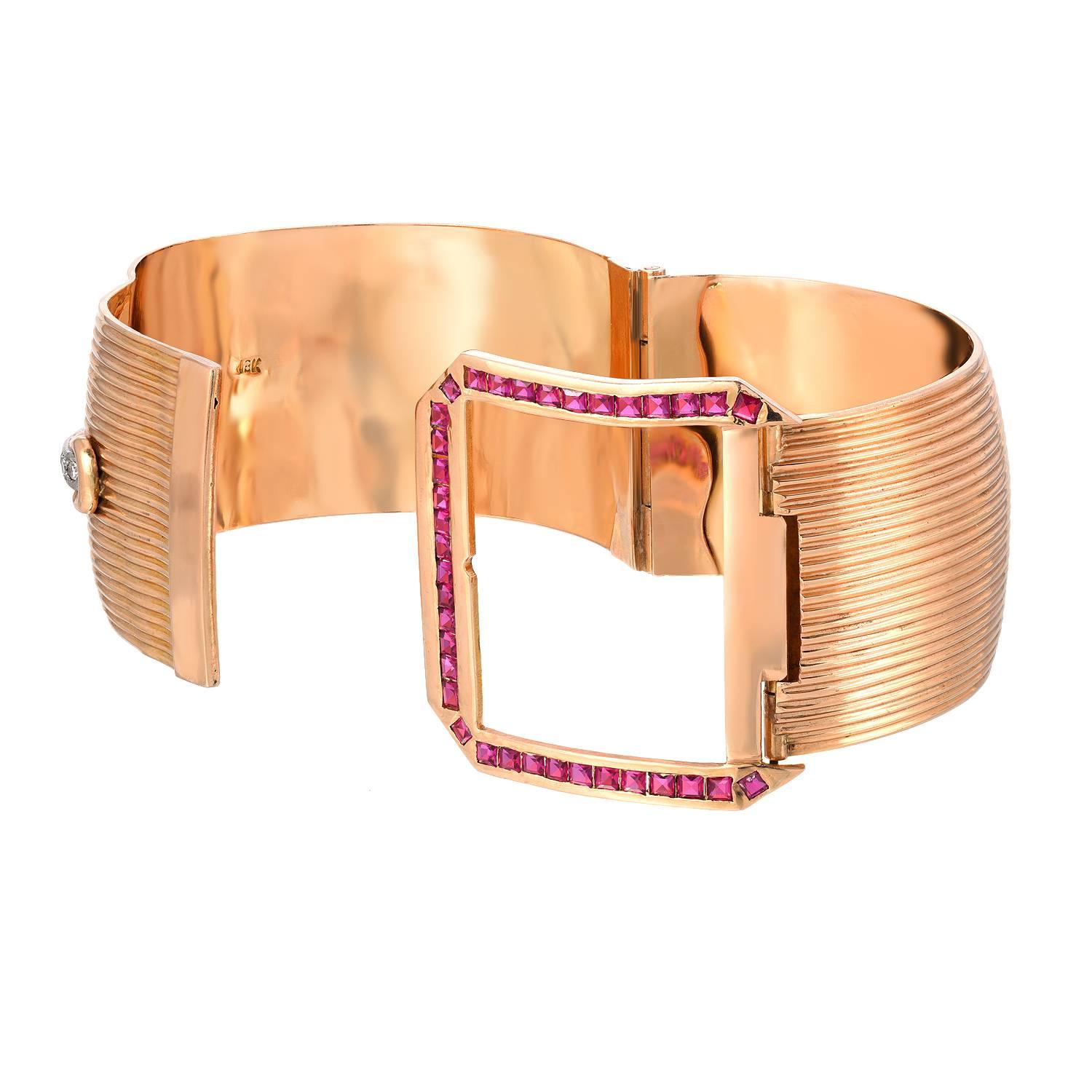 This beautiful 18K Yellow Gold Retro bracelet is a bangle, with a buckle closure. The buckle has carre cut rubies and graduated round brilliant diamonds. The closure is completely secure, as it follows a few steps. The gold is ridged and 1 3/8