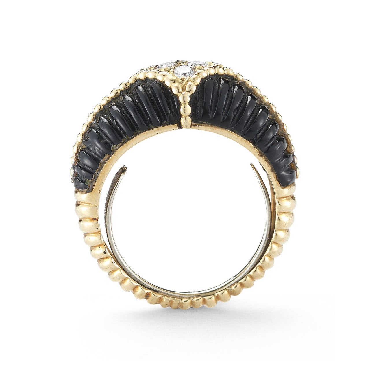 This chic and wearable Van Cleef & Arpels ring is designed as a carved black onyx scalloped band enhanced with gold beads and four circular-cut diamonds.  Ring size is 5 1/2. Signed Van Cleef & Arpels.