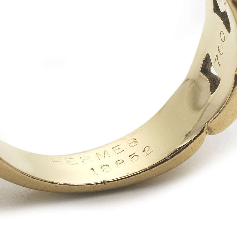 A classic and simple 18k gold buckle ring made by Hermes. The shank of this ring is a chain design. The buckle motif has been popular for centuries for its clean lines and fashionable undertones. Signed Hermes with French hallmarks present.This ring