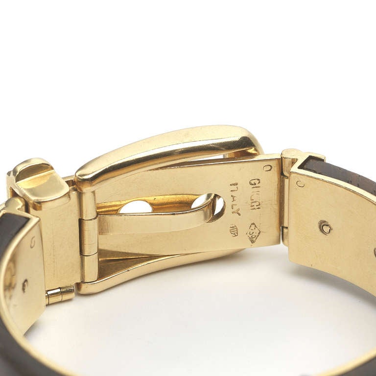 This Gucci wood buckle bracelet was made in the 1970s. The rare bracelet is made with 18k gold with mother of pearl detailing. It has a functional buckle closer. Signed Gucci.