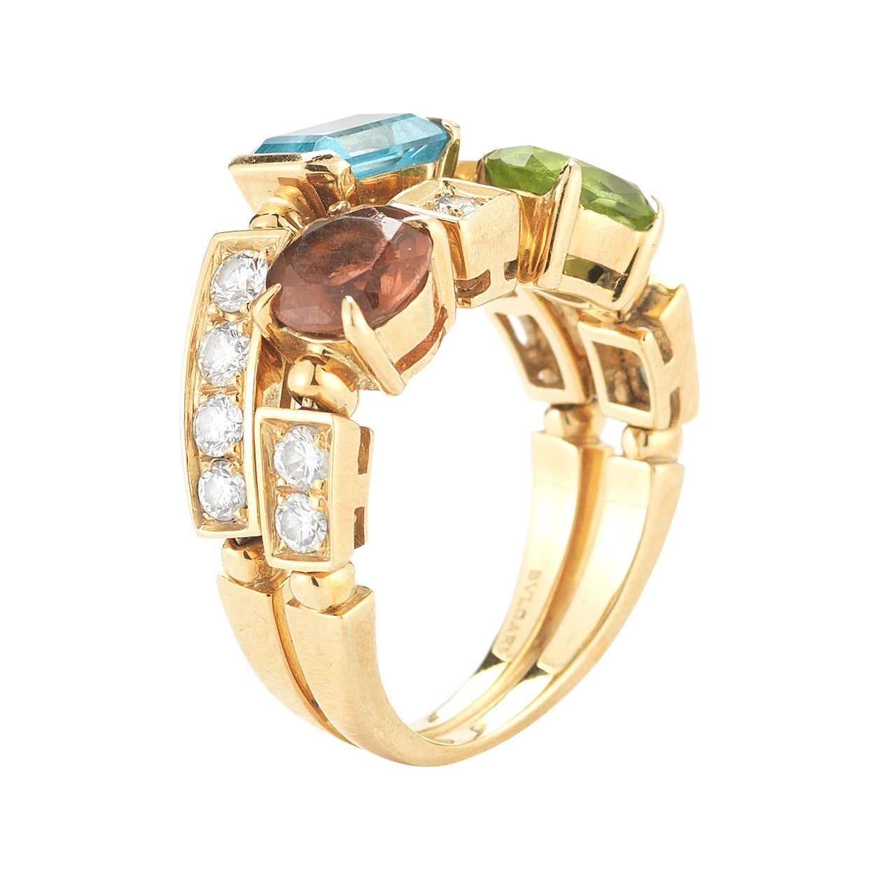 A beautiful and special 18K yellow gold BVLGARI ring from the Allegra Collection. This ring has alternating colored stones (citrine, tourmaline, blue topaz and peridot) and pave diamonds. It can be worn on any finger, for any occasion. Stamped