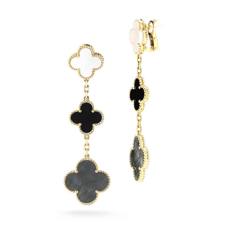 A beautiful, timeless pair of Van Cleef & Arpels Alhambra drop earrings with mother-of-pearl and onyx set in 18k yellow gold. In excellent condition, these earrings feature 3 clovers each, and are an instantly recognizable Van Cleef & Arpels design.