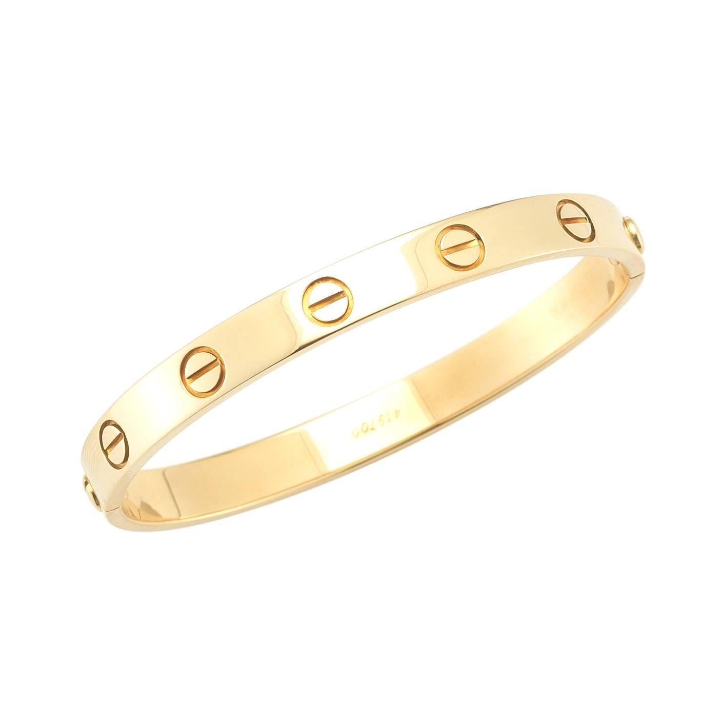 A classic, highly coveted Love bracelet by prestigious jeweler Cartier. This beautiful bracelet is a signature Cartier piece, and can be worn day and night. This particular bracelet has an old personal engraving on it - can easily be buffed out.