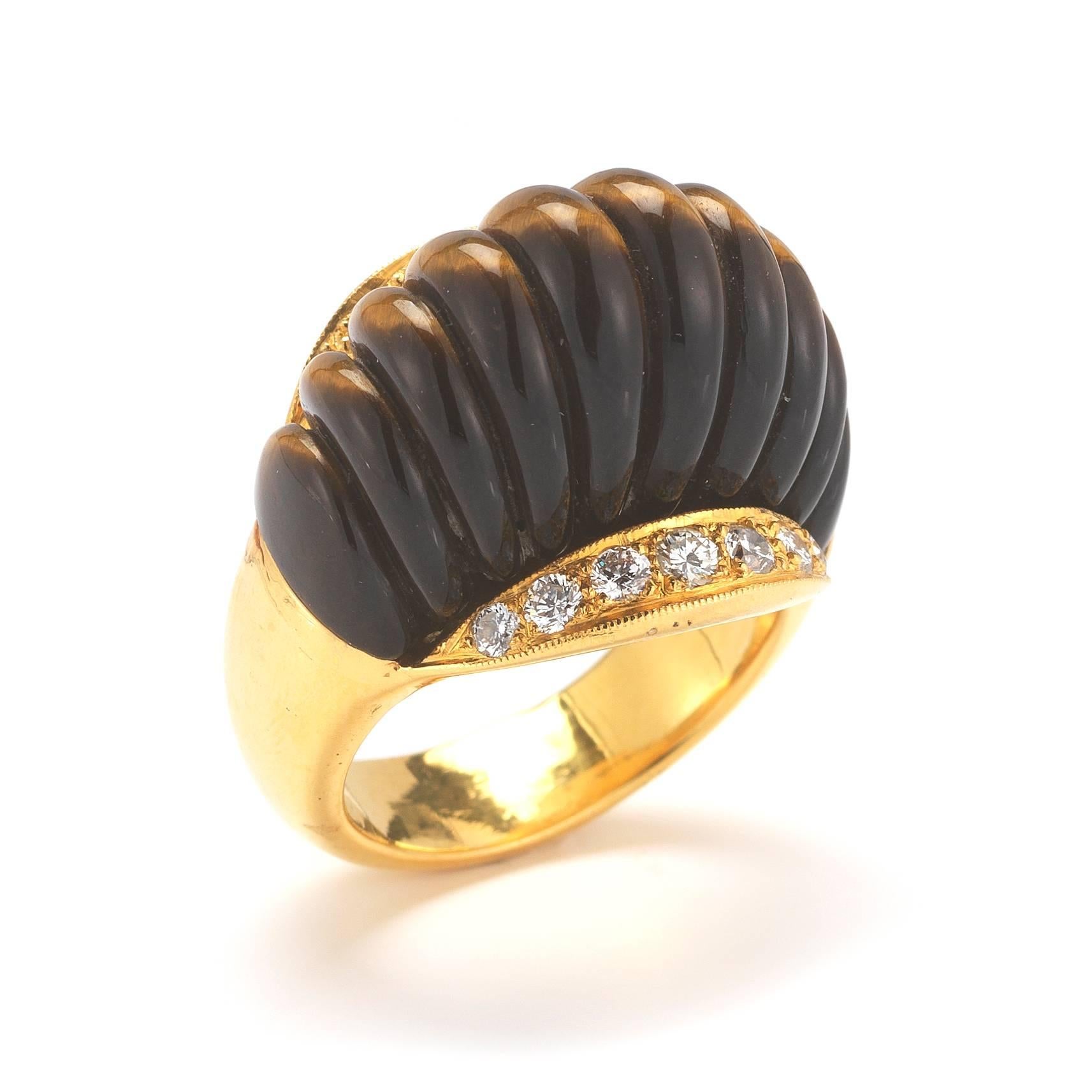 Stunning, unique Gucci ring set in 18K yellow gold. The ring features round brilliant diamonds (.75cts, GH/VS) and Tigers Eye. Size 8.