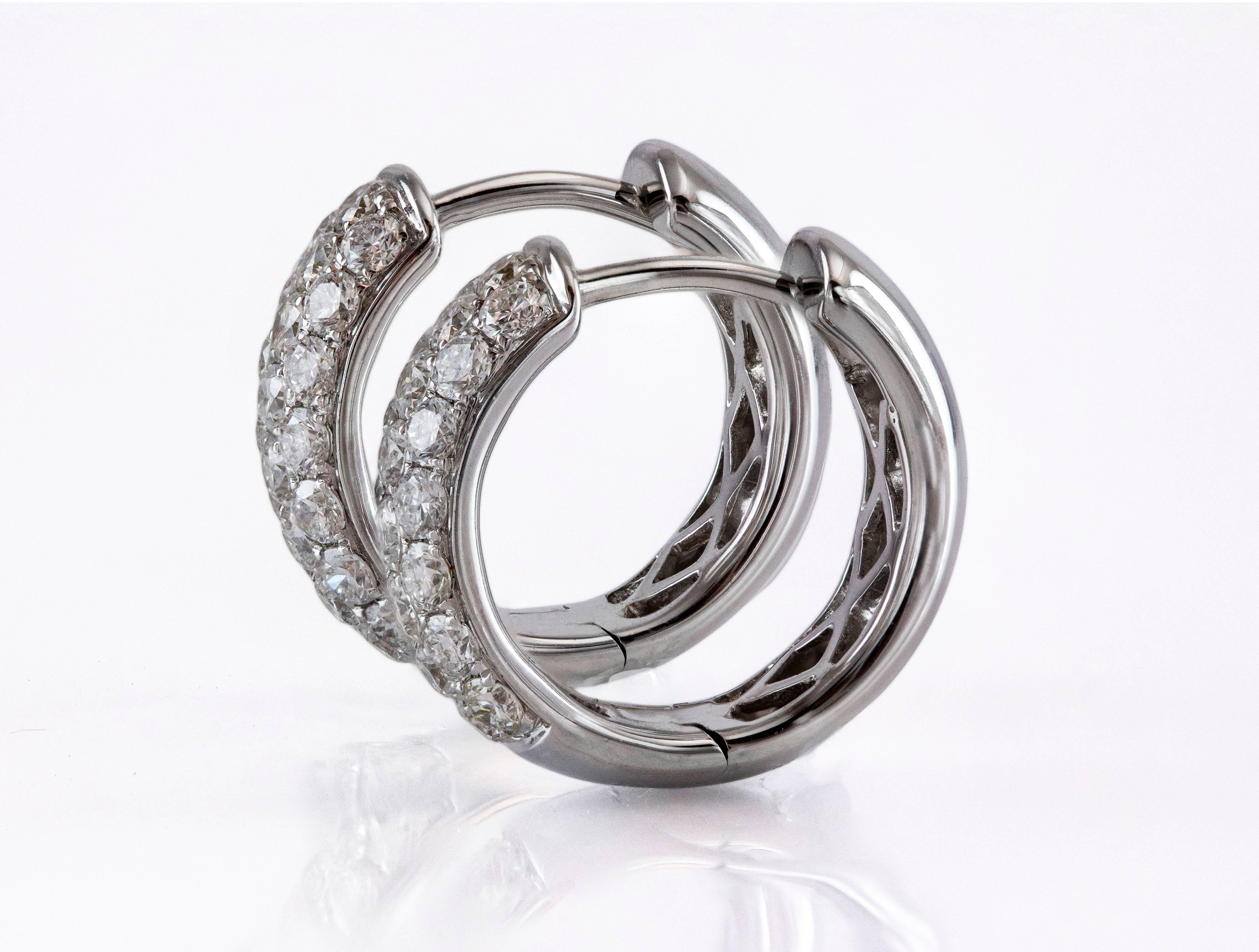 Beautiful huggie hoop earrings made with 18k white gold and set with 44 round brilliant diamonds weighing 0.95 carat total. The diamonds are F-G color and VS-SI1 clarity. These earrings made in 18K white gold. The diameter is 0.5in.