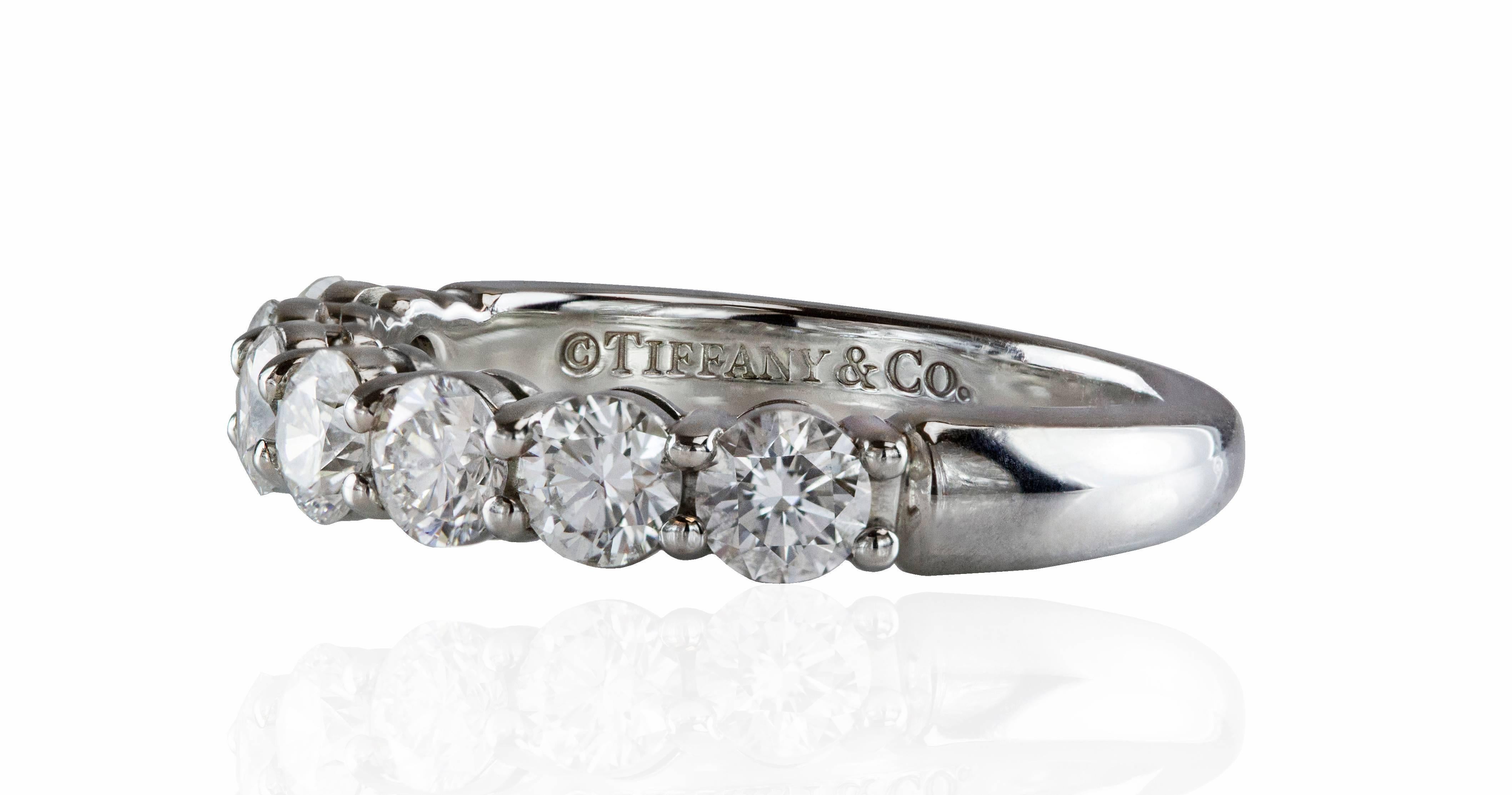 This ring features 7 brilliant round diamonds weighing 0.91 carats total. The ring is made in platinum. Made and signed by Tiffany & Co. Size 5 (sizable). 