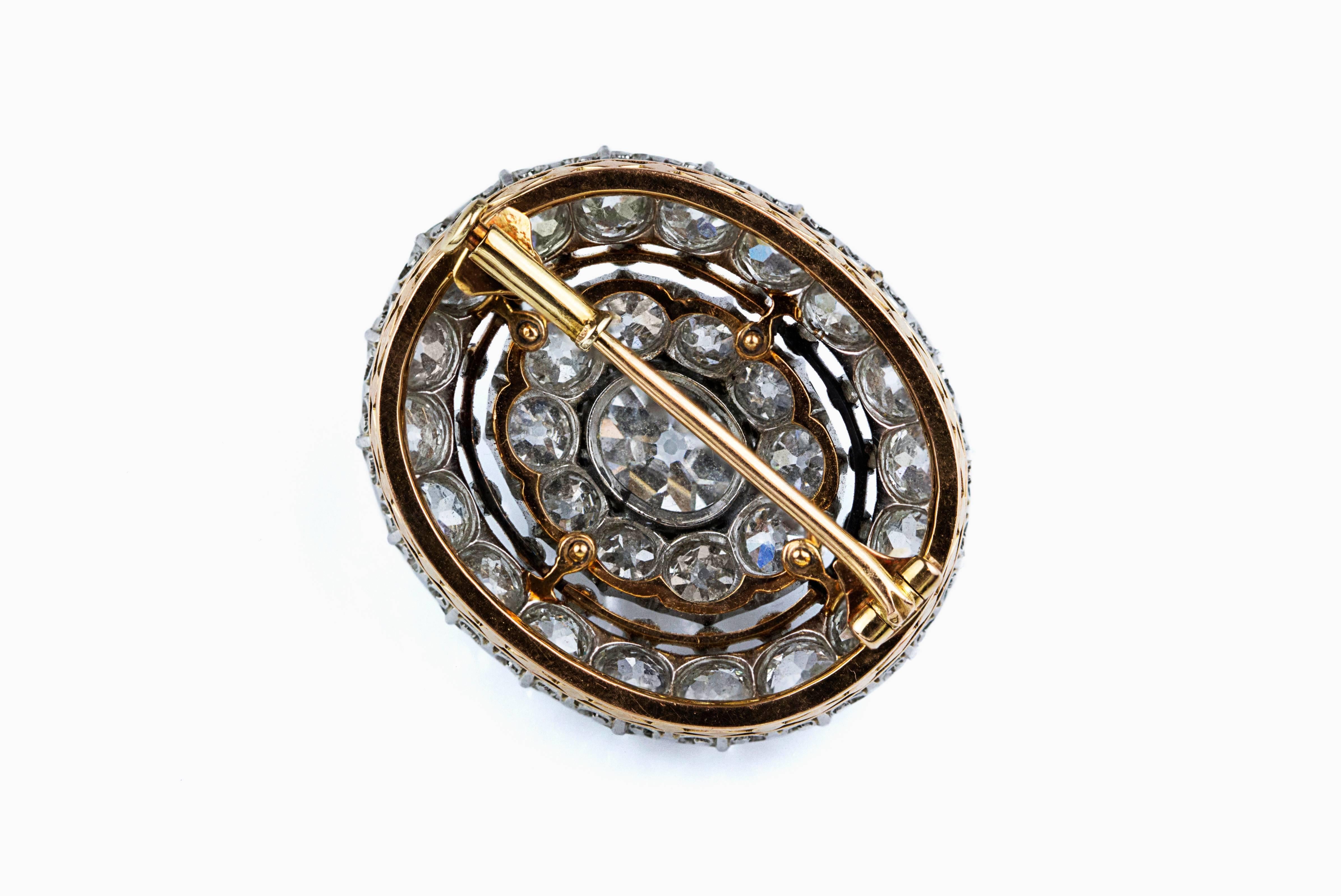 This antique brooch features an old mine cushion cut center stone diamond weighing 2.25 carats. The center stone is accented with 2 rows of old mine cut diamonds as well that weighs 8.50 carats. Made in platinum and yellow gold. An elegant and