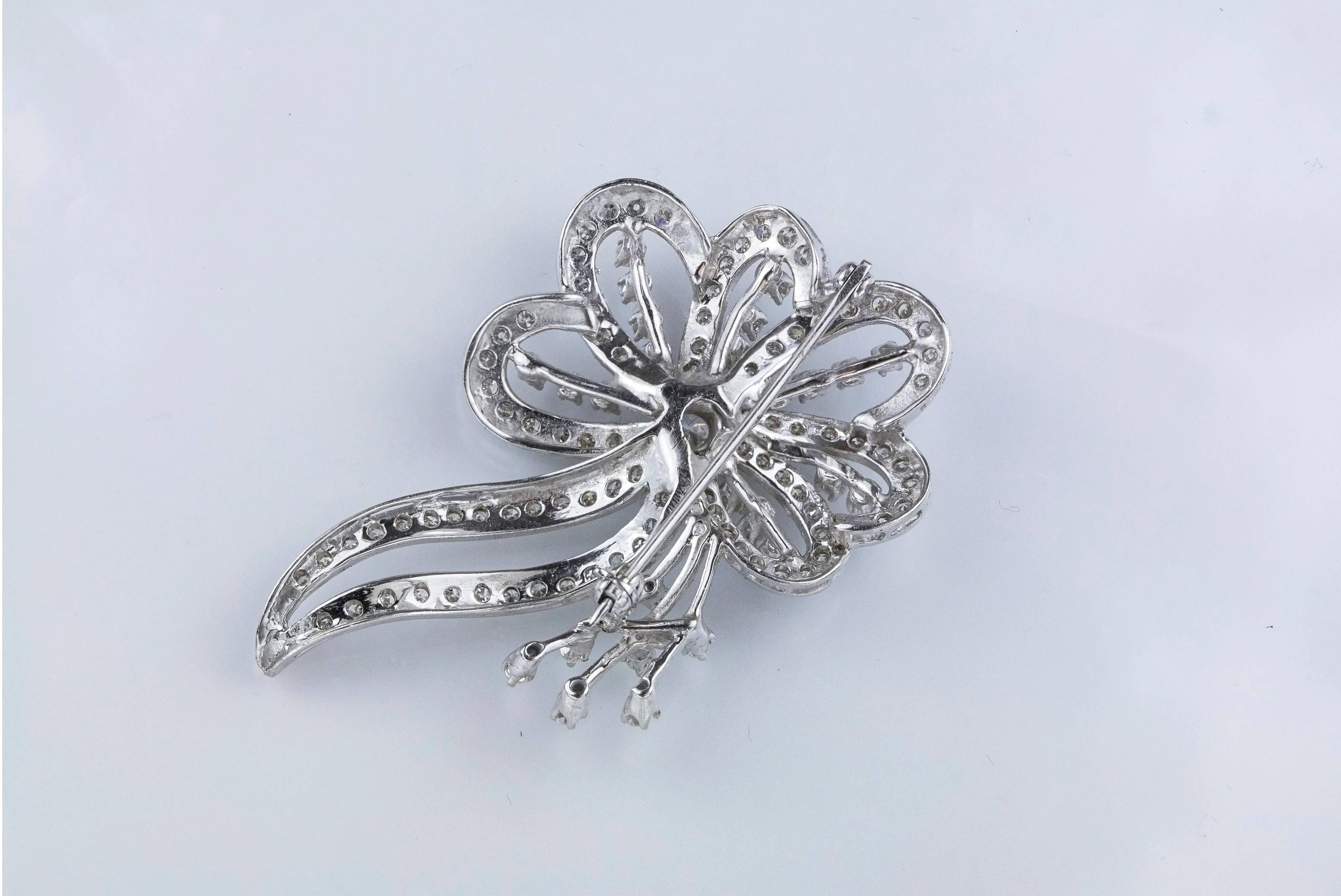 This brooch features a lovely flower design set with 116 brilliant round diamonds. The diamonds weigh 2.50 carats total. Made in 14k white gold. 