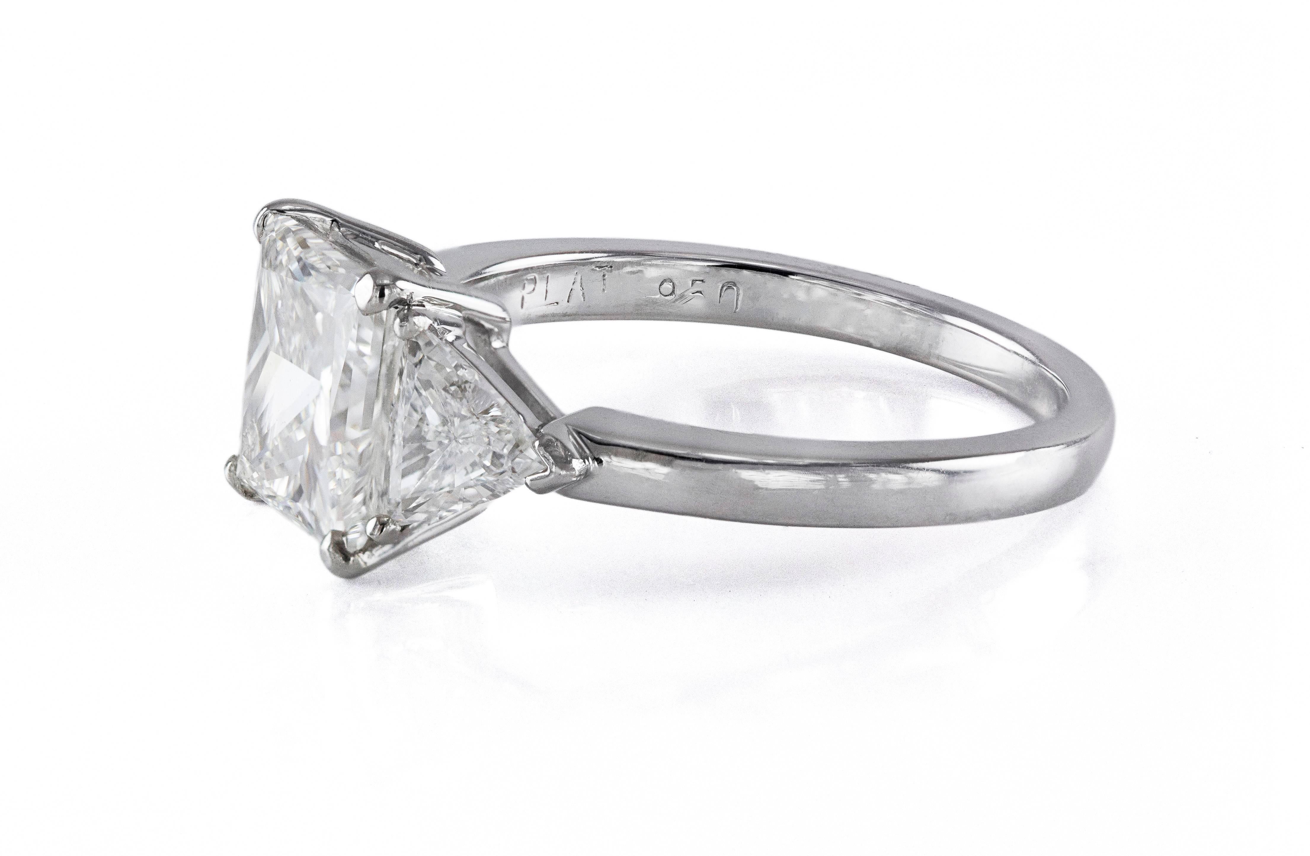 This engagement ring has a 2.51 carat Princess-cut diamond center stone accented by 2 trillion-cut diamond side stones weighing 0.65 carats total. Made in platinum. Size 7 (sizable).

Style available in different price ranges. Prices are based on