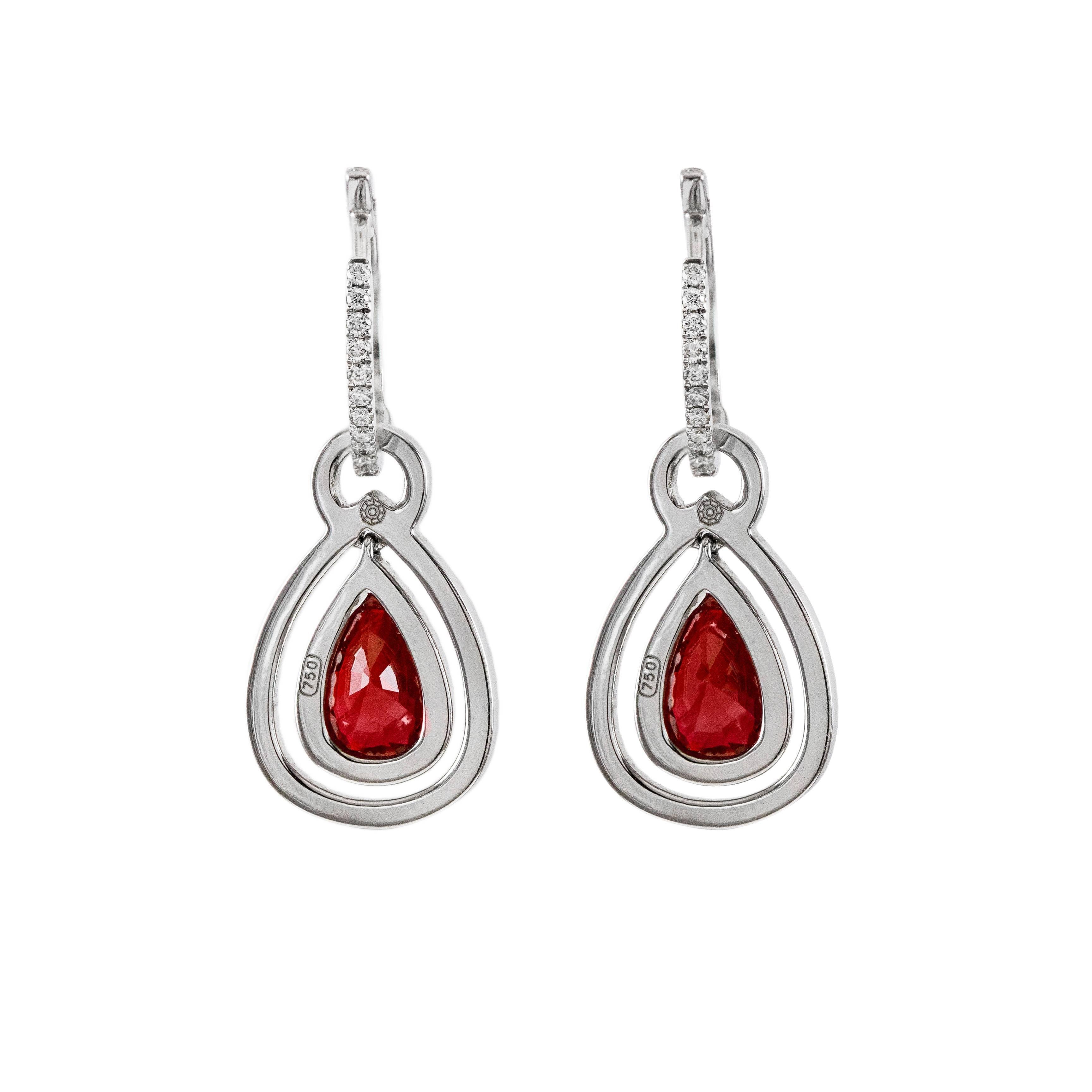 The 2 beautiful, eye clean rubies set on each earring weighs 2.08 carats total. These rubies are accented by 2 rows of brilliant round diamonds that go all the way up until the hinged earwire mechanism. The diamonds weigh 0.79 carats total. Made in