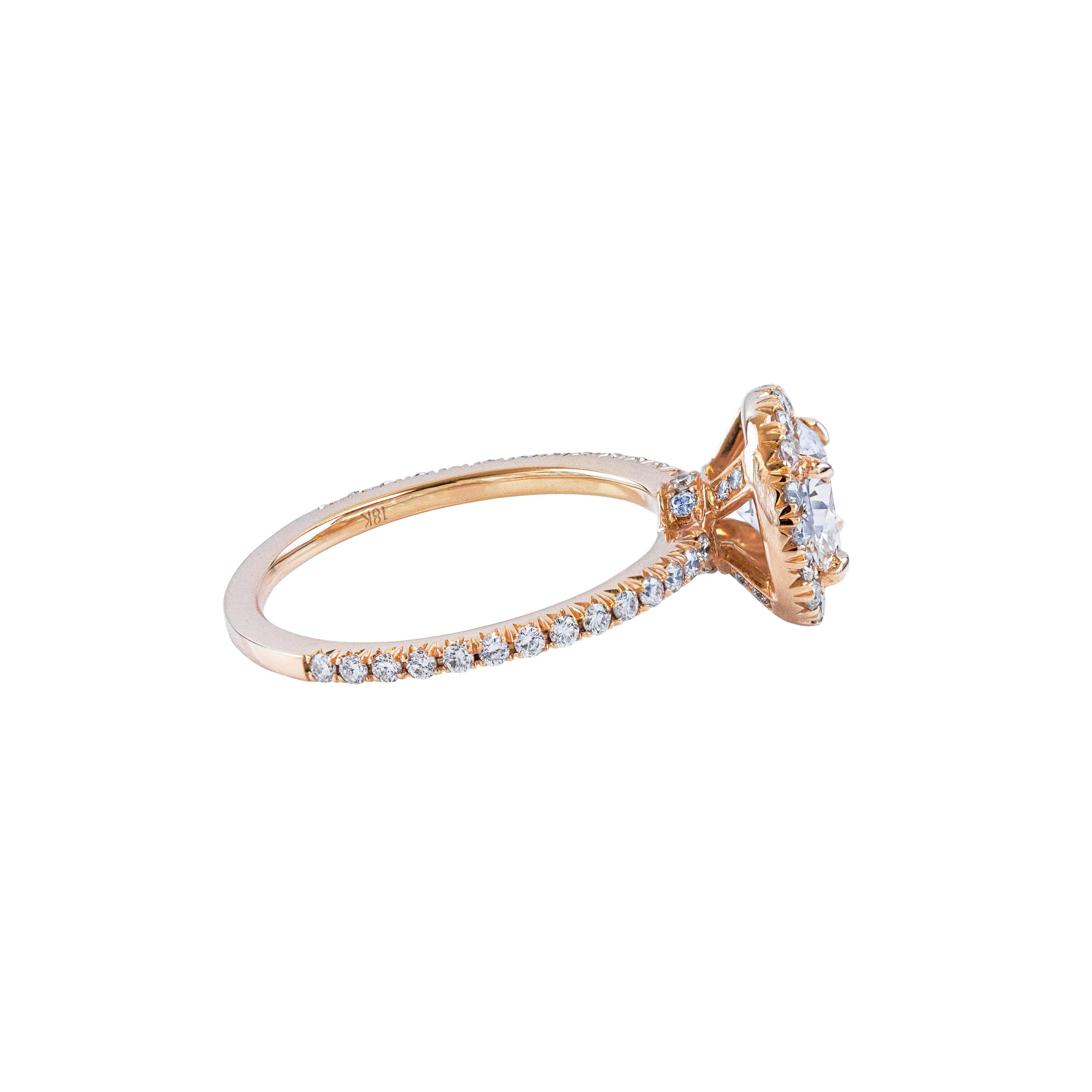 This ring features a well-crafted 1.07 carats brilliant round diamond center stone certified by EGL as E color and VS2 in clarity. Surrounded by round brilliant diamonds in a halo setting. Shank made in 18K Rose Gold is encrusted with diamonds set