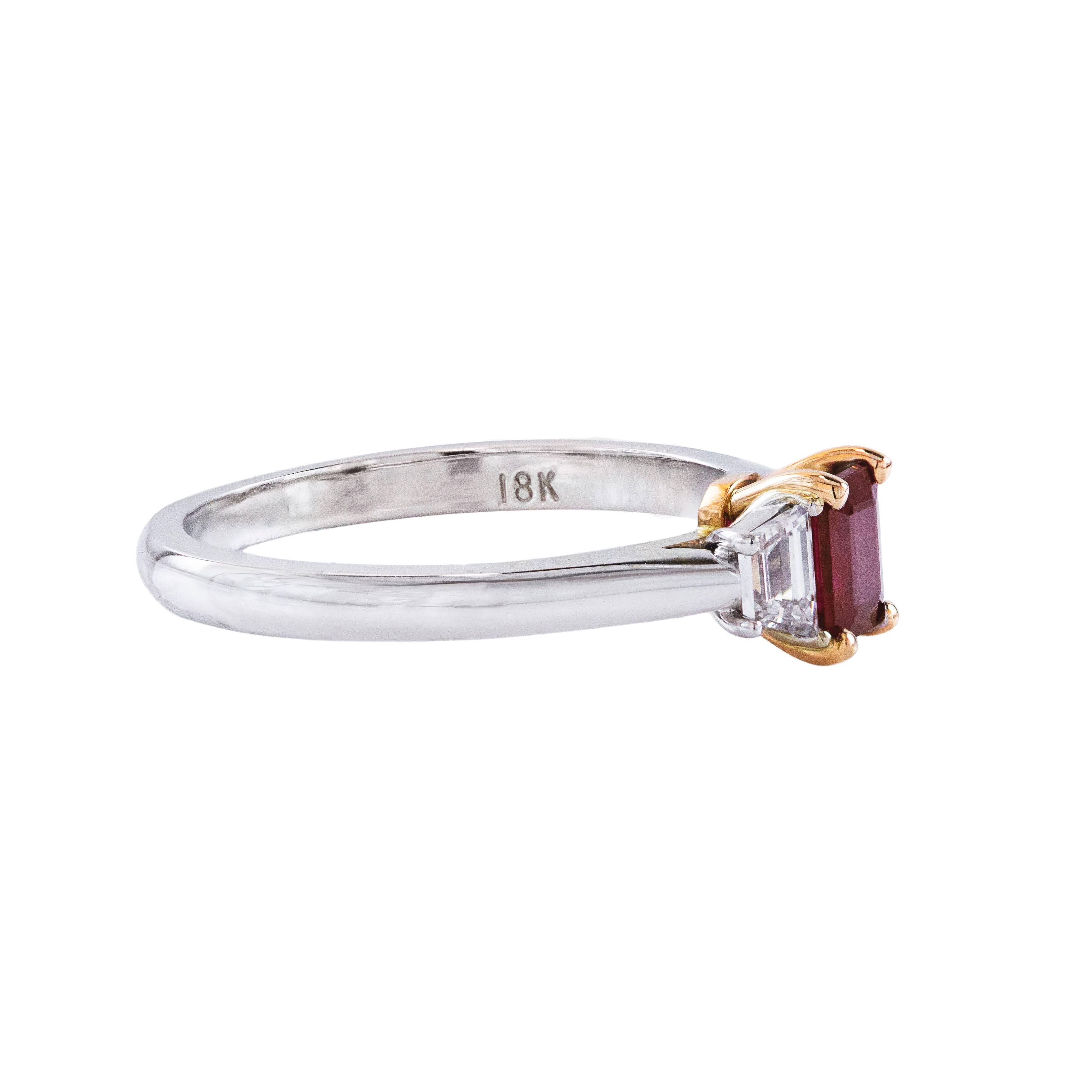 This ring features a gorgeous 0.47 carat emerald cut ruby with trapezoid cut diamond side stones weighing 0.26 carats. Set in 18k white gold. Size 6 1/4 (sizable). 

A simple but beautiful ring. 

Style available in different price ranges. Prices