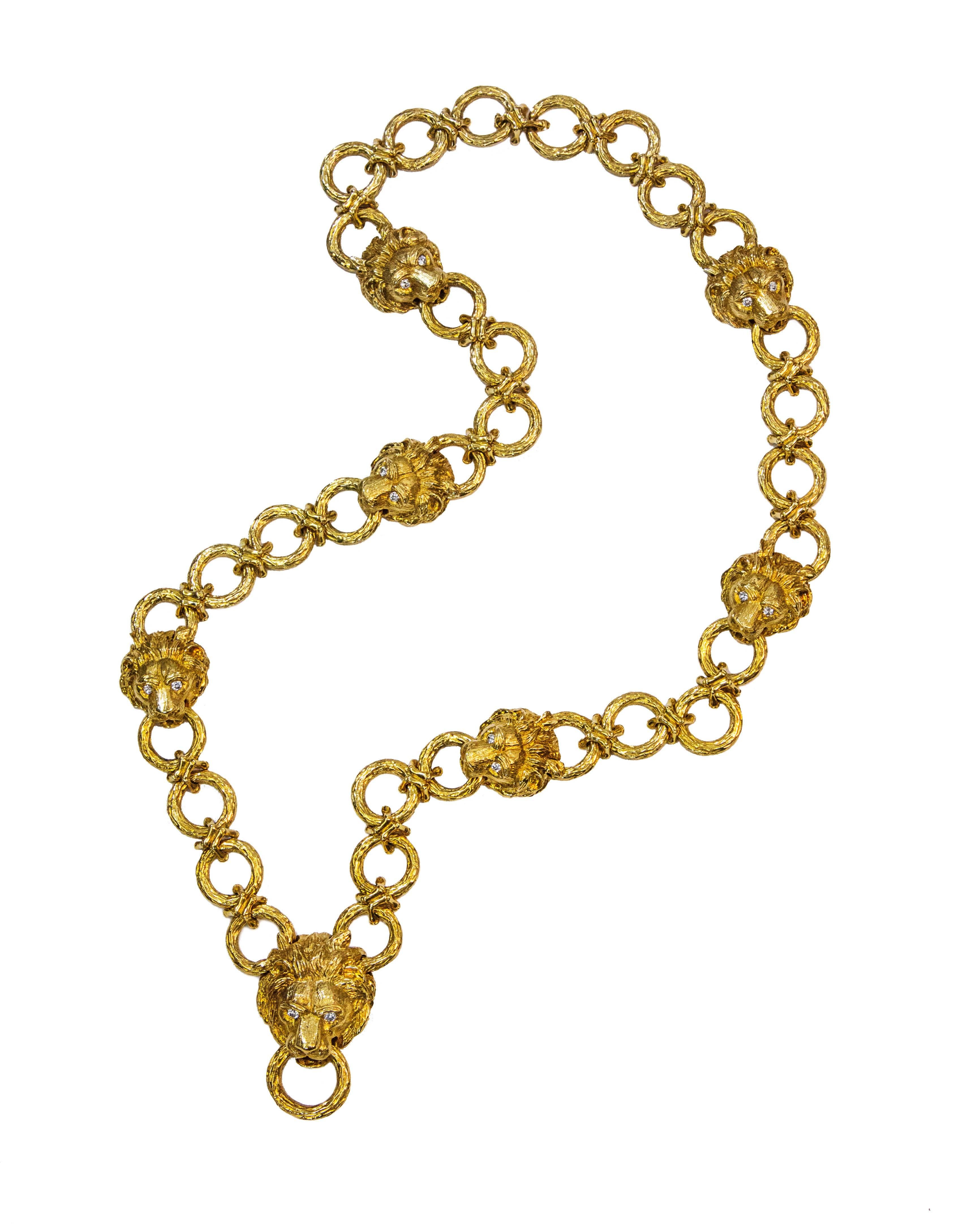 Made and signed by Van Cleef and Arpels approximately in the 1960's. The necklace, of long chain design, features hoops with seven lion heads throughout the necklace. The lion heads are set with fourteen round brilliant diamond eyes weighing 3.00