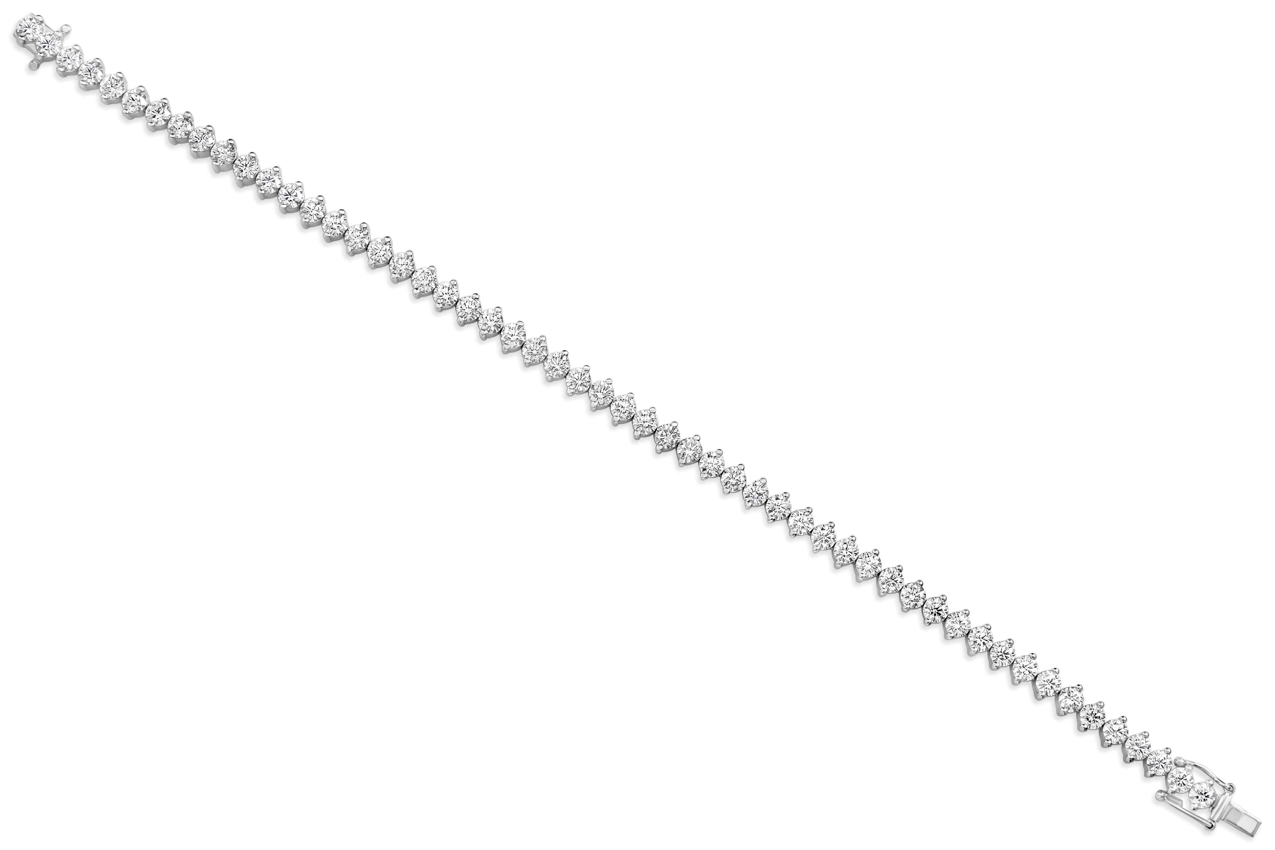 A unique tennis bracelet showcasing a line of brilliant round diamonds securely set in a two prong white gold setting. Diamonds weigh 7.26 carats total. Made in 18 karat white gold.

