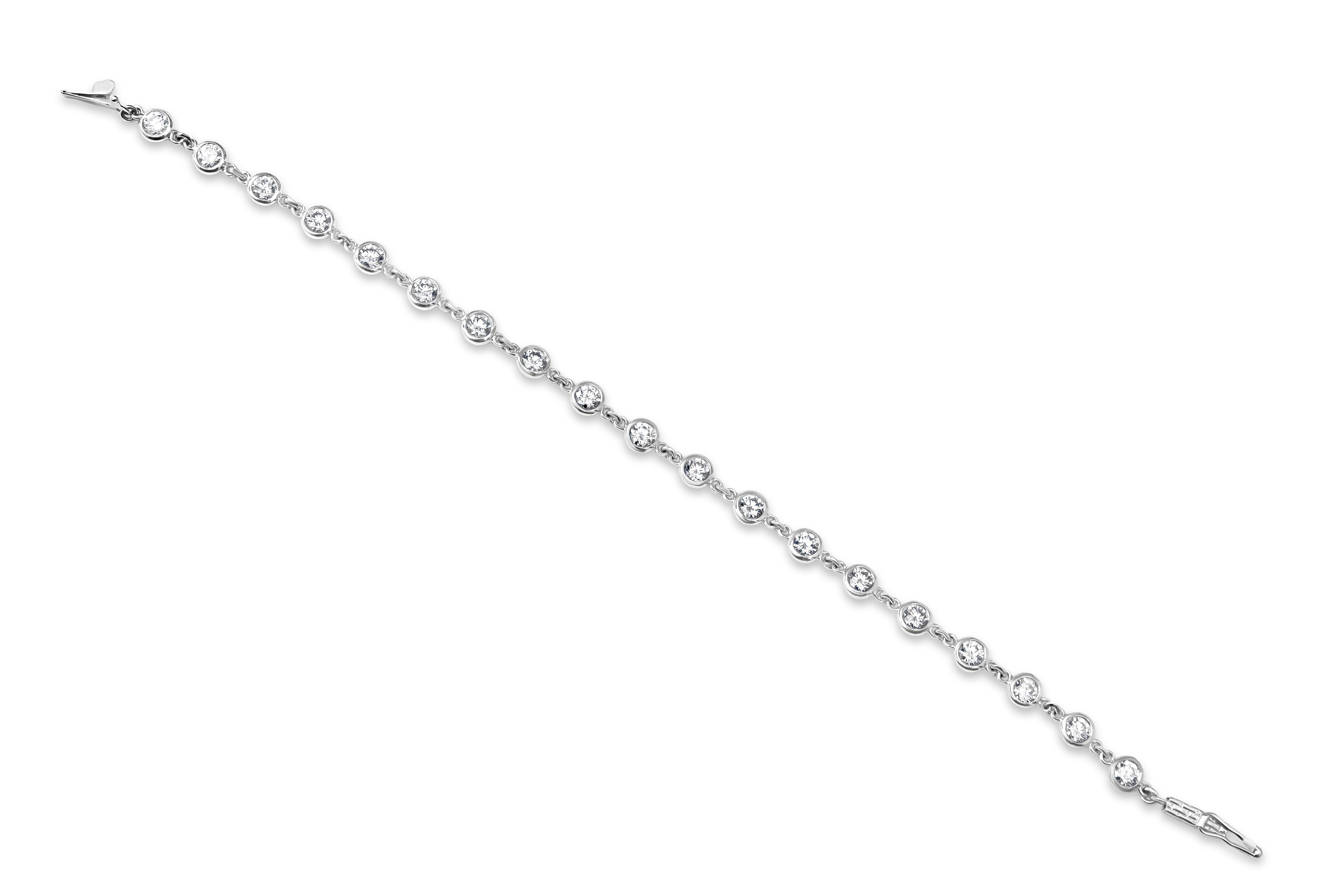 A modern bracelet showcasing round diamonds bezel set in platinum, spaced evenly on a 7 inch platinum chain. Diamonds weigh 2.87 carats total.
