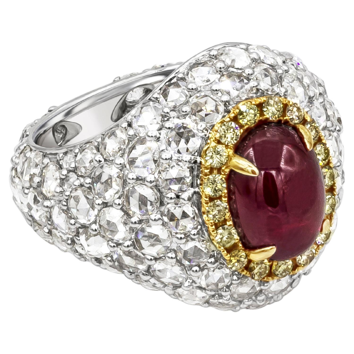 A stunning dome cocktail ring, showcasing a 3.76 carats cabochon ruby, set on a four prong setting and surrounded by a halo of round brilliant cut yellow diamonds.  Accented by beautiful rose cut diamonds weighing 4.27 carats total, set on a shared
