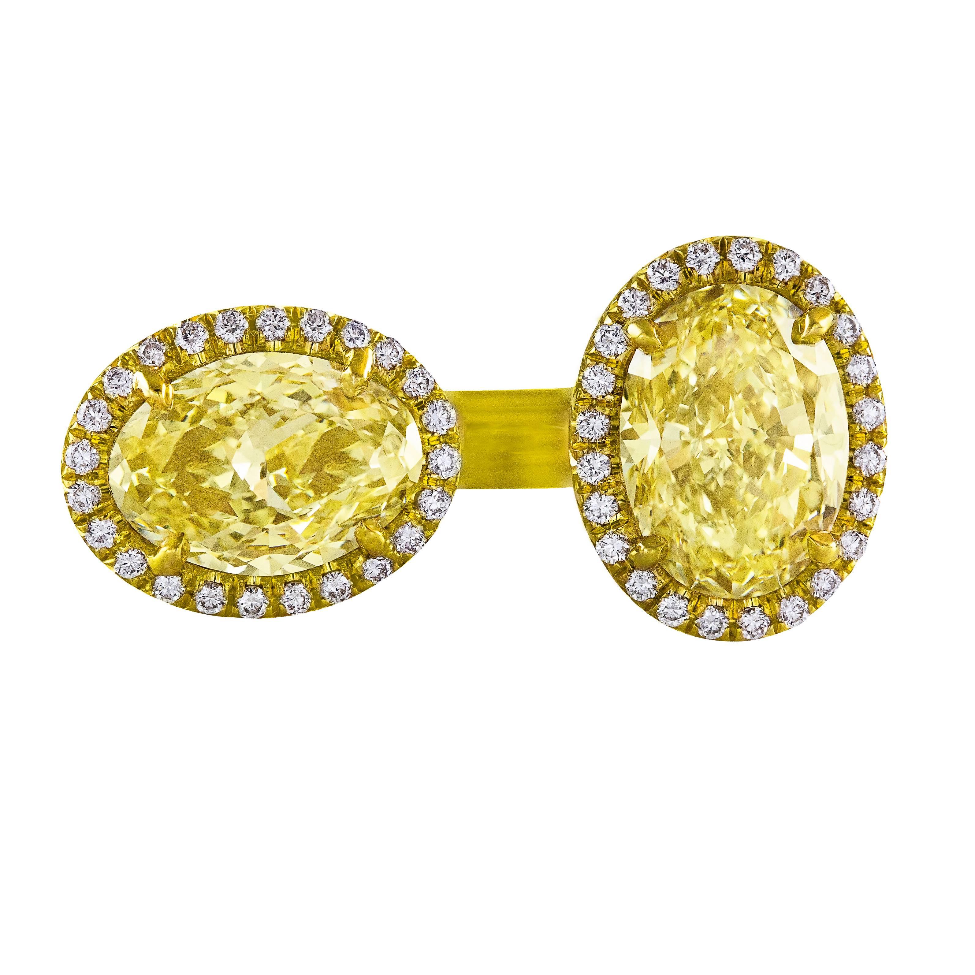 This ring features 2 oval diamonds weighing 2.76 carats total set perpendicular to each other in the open 18K yellow gold mounting. The diamonds are certified by GIA:
1.63 carat Y-Z color and VVS1 clarity GIA # 16243034
1.13 carat Fancy Light Yellow