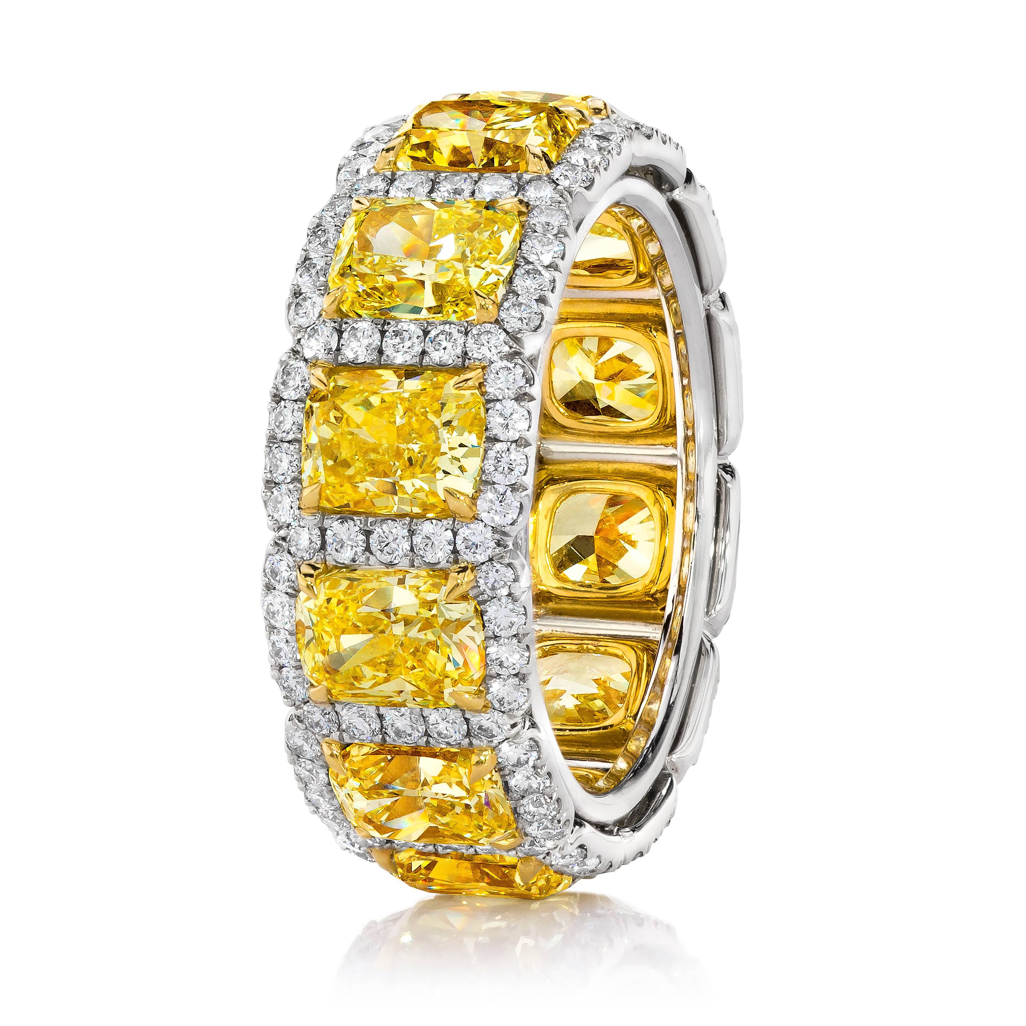 This wedding band features 12 cushion cut diamonds weighing 7.05 carat total. The diamonds are of Fancy Intense Yellow color and VS clarity. Each yellow diamond surrounded by the row of white round brilliant diamonds weighing 1.07 carat total. The