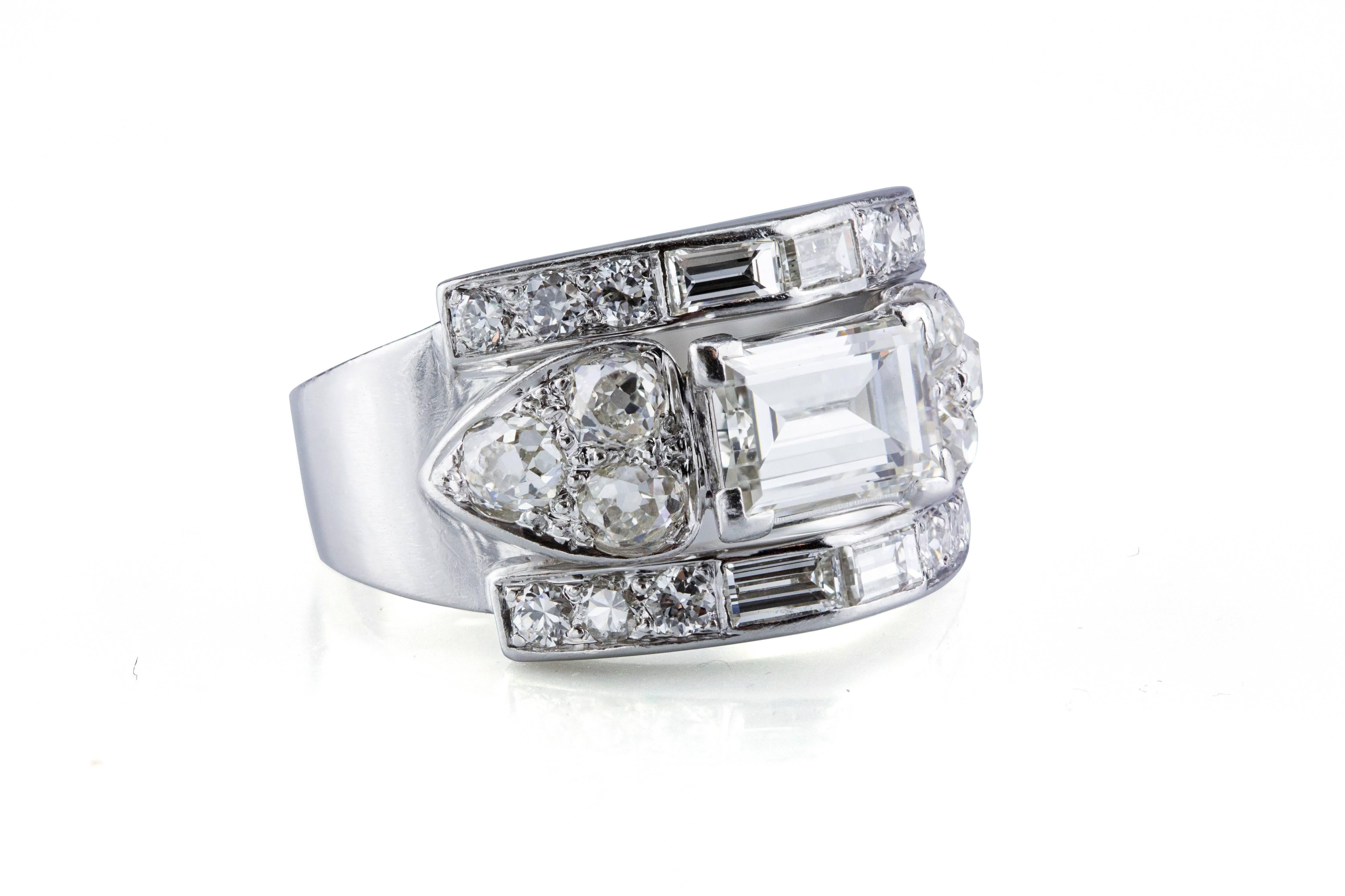 This ring features one 1.15 carat emerald-cut diamond in the center accented by  2 baguette diamonds on the top and bottom and by 3 Old Mine diamonds on either side. The weight of baguette cut diamonds is 0.40 carat, the weight of Old Mine cut